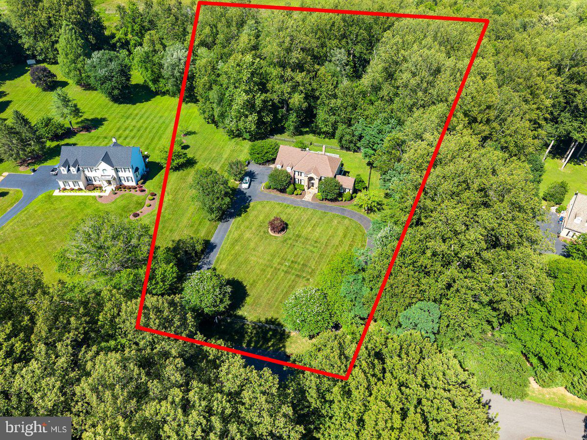 OPEN SUNDAY June 21st 2pm - 4pm! 6 BRs | 4.5 BAs | 3-car Garage | 5,248 finished sq ft | Wraparound Deck | 5 flat acres. Spectacular opportunity to own a private estate on 5 usable acres - recent refresh include luxury paint, new lower level carpet, extensive exterior landscaping & garden design, trim and deck work, and new contemporary light fixtures. 

The dramatic, circular driveway has enough private parking to host large-scale entertaining events and significant green space (complete with a mature, central Japanese Maple-feature) to setback the main house.  A custom, 3-tiered waterfall fountain with slate wall surround adds a whimsical touch of magic to the landscape design.  The fountain will convey as-is.

Extensive, Open Concept Main Level features a 2-story Family Room with Gas Fireplace, separate Office with natural Oak walls and built-ins + a separate Living Room, dedicated Dining Room, and Florida-inspired Sun Room with luxury white tile and double glass entry doors that lead to the wraparound Deck.  The Kitchen features a Solarium-inspired Breakfast Room within a completely-renovated Kitchen.  The Kitchen brings a Mediterranean flair with luxury Cream cabinets and upscale, weathered granite countertops.  The appliance suite is designed for the home chef - Sub-Zero refrigeration, GE Monogram gas Cooktop & hidden Dishwasher, and KitchenAid Convection Ovens.  The primary deck off the Solarium and Family Room overlooks the tranquil, lush backyard that includes a fenced-area leading to additional, wooded acreage for extra privacy not commonly found in Northern Virginia luxury properties.

The Upper Level features 4 bedrooms, with emphasis on the primary suite that includes a bonus Sitting Room, 2 large walk-in closets, and a massive primary bathroom with a Jacuzzi Tub, built-in window sitting areas, and bonus storage.  The 3 additional bedrooms are all oversized with 2 additional full bathrooms with tub showers.

The fully-finished, walkout Lower Level extends the entertaining and functional living space.  A bar area is built into the main Rec Room, with space for both lounging and exercise equipment.  Around the rear is a separate, walkout entry door to the hardscaped back patio and includes a multi-use kitchenette, full bathroom, and 2(!) more bedrooms to create a standalone, secondary living area.

Seller requests 30 day rentback. ES: Fairview / White Oaks (AAP), MS: Robinson / Lake Braddock (AAP), HS: Robinson. House is on private well and septic.