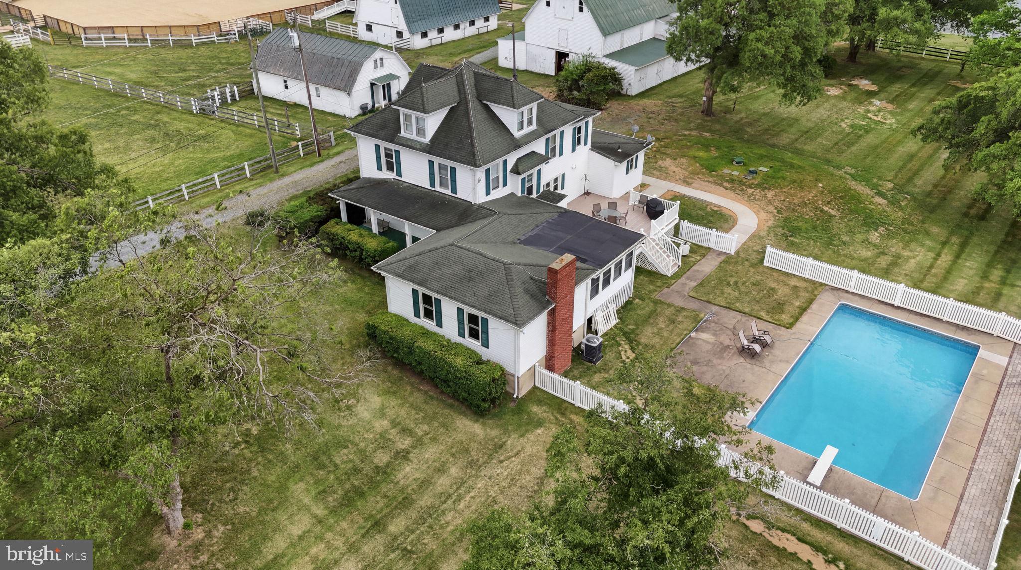 Mulberry Farm: 57-Stall Premier Equine Facility with 1912 Estate Home with Farmhouse Charm

Mulberry Farm is a turn-key equine estate configured for professional training, boarding & large-scale events. An established venue for cutting, barrel racing, English lessons & clinics, the property combines a natural pond & pastures with premium, multi-barn infrastructure totaling 57 stalls. Built for operational efficiency, dedicated paths connect all buildings, keeping horse movement separate from vehicle areas.

The training & event infrastructure features 2 main arenas & extensive overnight amenities. The 140'x80' indoor arena building integrates 30 center-aisle stalls along its sides (13 stalls on one side, 17 on the other) over durable concrete floors. Stalls measure 12'x12' (except two 12'x24' foaling stalls) & include individual lighting & fans. Stall lights & fans on the 17-stall side were replaced in 2026; those on the 13-stall side are under 4 years old. This building also features an oversized tack room, full kitchen, concrete wash stalls with hot water & an upstairs spectator lounge. This facility operates on its own independent electric meter, with water from a dedicated 350-ft well maintaining consistent pressure at 48 ft.

Supplementing the indoor space is a 140'x140' outdoor event arena with exterior lighting, an elevated judges' stand, a 10'x40' spectator platform & 20 dedicated RV hookups. Positioned adjacent to the outdoor arena, the 2-story, 25'x40' "Hen House" has its own dedicated electric meter, offering a premier setup for event-day concessions, a tack shop or vendor retail. A dedicated exterior wash station is located at the outdoor arena for immediate cooling.

Specialized stabling & outbuildings offer extensive infrastructure for diverse operations. A renovated original barn adds 10 center-aisle 12'x12' stalls & 10 exterior 10'x10' stalls, complemented by an adjacent detached 2-car garage. For breeding or rehab, a separate 60'x108' barn houses 7 oversized specialty stalls (one 12'x24' with tack room space), two 24'x36' & four 24'x24'). A 30'x50' original Dairy Barn provides substantial storage or event venue potential. Flowing out from the facilities, turnout infrastructure includes multiple paddocks across the property, with rear paddocks featuring 2 functional run-in sheds & an automatic waterer.

The main house, built in 1912, offers 4,500 total sq ft of living space (3,500 sq ft above grade) & operates on an all-electric system with 2 panels shared between the house & original barn. Water for both is supplied by the primary house well, serviced by a shared, dedicated UV water filtration system. A new 5-bedroom perc septic system was installed May 2026. Climate control is managed by 3 HVAC units (one replaced 2025, two are 15 years old & regularly serviced) & the roof is approx 15 years old.

The home's main level includes a primary bedroom with full bath, formal living, dining, family room with brick fireplace, sunroom, kitchen & an oversized mudroom remodeled in 2023 with a half bath. The upper level provides 4 additional bedrooms & 2 full baths (1 en-suite), plus a finished attic with HVAC. Outside, a composite deck leads to an operational 20'x40' concrete in-ground pool with a diving board & all components working.

The indoor arena space is occupied by a tenant (Prestige Training) who wishes to remain. Unrivaled potential to scale operations into a premier mid-Atlantic equestrian hub by expanding the competition calendar, establishing high-volume summer clinics or increasing boarding capacity across multiple specialized disciplines.