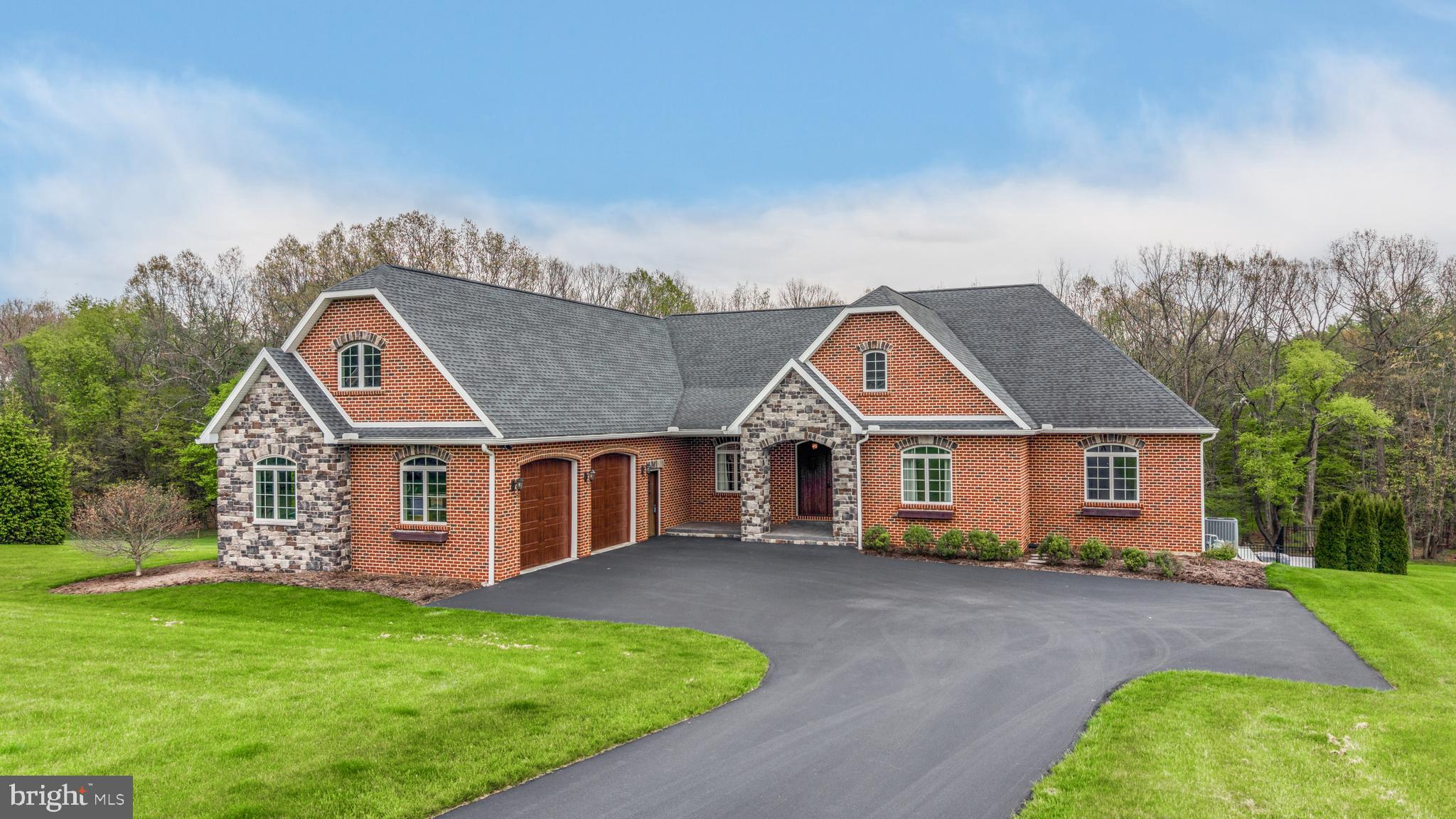An extraordinary and rare offering in the prestigious Ambleside development, this custom residence is set on one of the community’s most private and coveted homesites. Showcasing impeccable craftsmanship, curated materials, and sophisticated design, this home represents a seamless blend of elegance and modern comfort. Designed for effortless main-level living, the home features a flowing open-concept layout that is both refined and inviting—ideal for intimate gatherings or grand-scale entertaining. The chef’s kitchen serves as a stunning focal point, marrying form and function with exquisite finishes and thoughtful detail. Throughout the home, timeless design elements and a cohesive aesthetic create an atmosphere of quiet luxury. The walk-out lower level is a destination unto itself, offering an exceptional collection of lifestyle amenities. A full indoor basketball court provides a rare and dynamic space for recreation, fitness, or creative pursuits. The adjoining exercise studio, framed by floor-to-ceiling windows and elegant French doors, offers a tranquil setting with picturesque views of the surrounding landscape and pool. Additional spaces include a beautifully appointed family lounge with a well-equipped kitchenette and seamless access to the outdoor living areas. A dedicated studio with an entertainment stage adds a distinctive and imaginative element—perfect for performances, artistic expression, or bespoke use. Outdoors, a private resort-style setting awaits. The saltwater pool, enhanced by a serene water feature, is surrounded by lush greenery, offering both beauty and seclusion. The expansive, level grounds provide ample space for recreation, entertaining, or simply enjoying the peaceful surroundings. This is a home where every detail has been considered, and every luxury thoughtfully integrated offering a lifestyle of comfort, privacy, and distinction. Welcome to 156 Brothers Court!