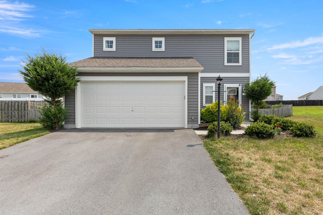 This beautiful 3 bedroom 2.5 bath home offers a perfect blend of comfort and modern living. The heart of the home is the open kitchen, complete with upgraded countertops, a convenient island, and stainless steel appliances, including a self-cleaning oven and built-in microwave. A generous pantry ensures ample storage for all your culinary needs. The open living area is enhanced by recessed lighting and ceiling fans, creating a warm ambiance throughout. With three  nice sized bedrooms, including a primary suite with a walk-in closet and ensuite bath, this home provides plenty of space for relaxation. The two and a half bathrooms are thoughtfully designed, offering both style and functionality. Step outside to enjoy the beautifully landscaped yard, which backs onto an open common area, providing a serene backdrop for outdoor gatherings or quiet moments. The front yard adds curb appeal, while the side yards offer additional space for gardening or play. Parking is a breeze with a two-car attached garage and ample driveway space. Enjoy your fenced yard with relaxing patio, a large shed for storage and easy access to common area and community play ground. Owner has recently installed a new water softener. This property is not just a house; it's a place to create lasting memories. Experience the comfort and convenience of this lovely home today!
