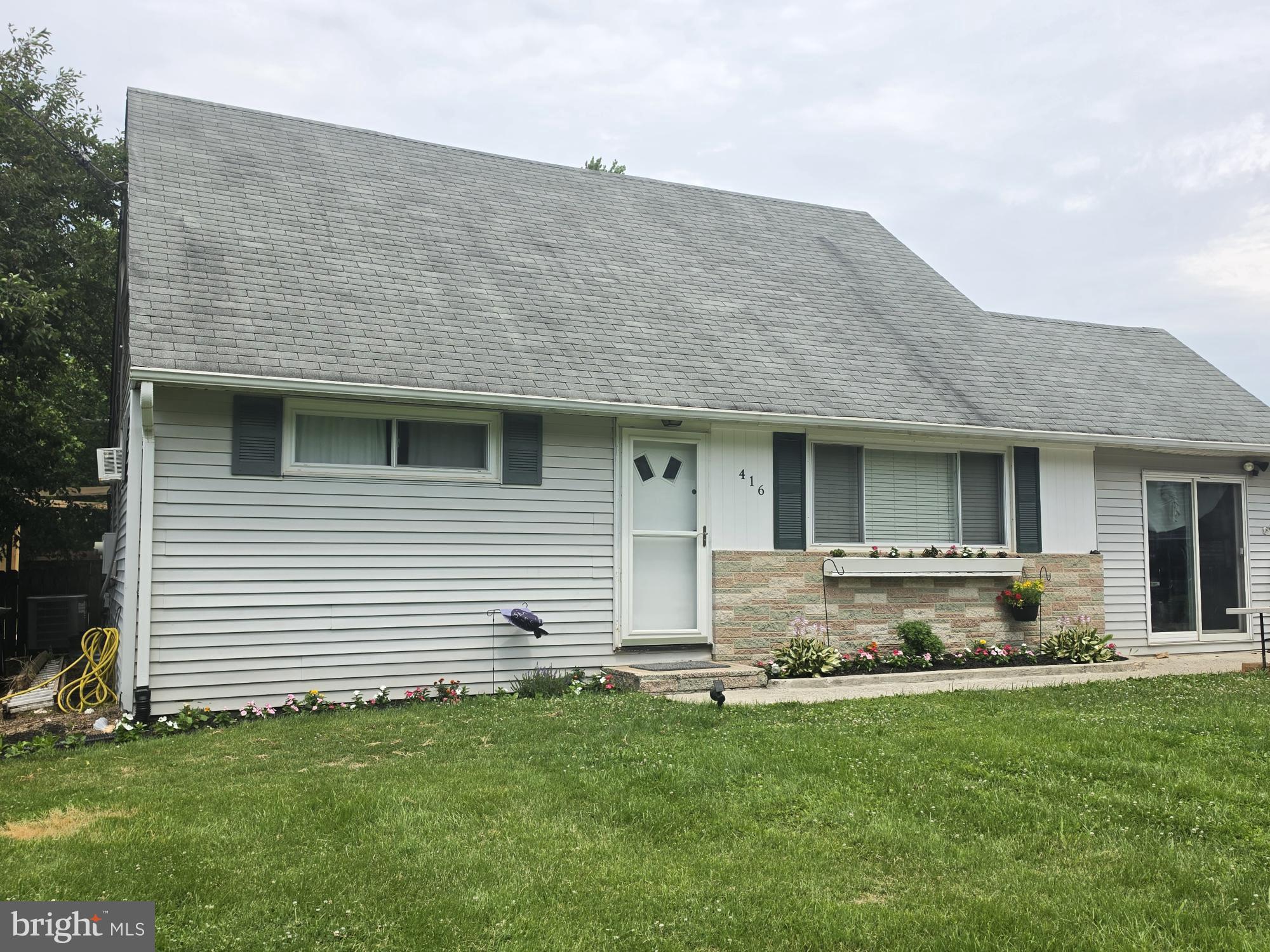 This charming Cape Cod home, built in 1956, offers a perfect blend of classic character and modern convenience. With 1,694 square feet of thoughtfully designed living space, this residence features four spacious bedrooms and two full bathrooms, ensuring ample room for relaxation and privacy. Step inside to discover an inviting open floor plan that seamlessly connects the combination kitchen and dining area, ideal for both casual meals and entertaining. The kitchen is equipped with stainless steel appliances, including a self-cleaning oven and built-in microwave, making meal prep a delight. The main floor laundry adds convenience to your daily routine, while the entry-level bedroom offers flexibility for guests or a home office. Beautiful flooring choices, including hardwood, luxury vinyl plank, and carpet, create a warm and welcoming atmosphere throughout. Outside, the expansive 0.46-acre lot backs to serene trees, providing a peaceful retreat. The level yard is perfect for outdoor activities, and the landscaped front yard enhances curb appeal. A detached oversized garage offers ample storage and parking, with a private gravel driveway for added convenience. This home is not just a place to live; it’s a sanctuary where comfort meets functionality, ready to create lasting memories.