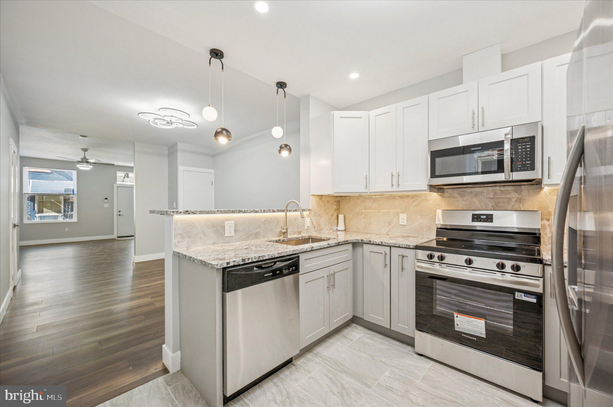 Step into elegant comfort with this beautifully completely renovated 3-bedroom, 2 bathroom home, where charm meets modern luxury. Thoughtfully redesigned from top to bottom, this home showcases a flowing open-concept layout, stylish finishes, and exceptional attention to detail throughout. The light-filled main level features wide-plank wood-style flooring and a neutral designer palette that enhances the home’s airy and inviting atmosphere. The elegant living room centers around a stunning gas fireplace with a classic mantle—perfect for cozy evenings and entertaining. At the heart of the home, the gourmet kitchen boasts granite countertops, gorgeous custom cabinetry, stainless steel appliances, and pendant lighting above a breakfast bar that opens seamlessly to the dining room.   Both bathrooms have been completely renovated with sleek, modern fixtures and tasteful tile work, offering a spa-like experience. The three spacious bedrooms provide comfort and flexibility, ideal for guests, home office space, or every day living.  Step outside to your private backyard oasis—featuring a new patio and a fully fenced yard. Whether you're enjoying morning coffee, hosting summer barbecues, or gathering around a fire pit under the stars, this space is designed for relaxation!  Additional features Include:  3 spacious bedrooms, 2 fully renovated bathrooms, gas fireplace with custom mantle, recessed and designer lighting, new heater and air conditioner, and main floor laundry room.  Nothing to do here...just move right in!  Schedule your private tour today and make an offer!