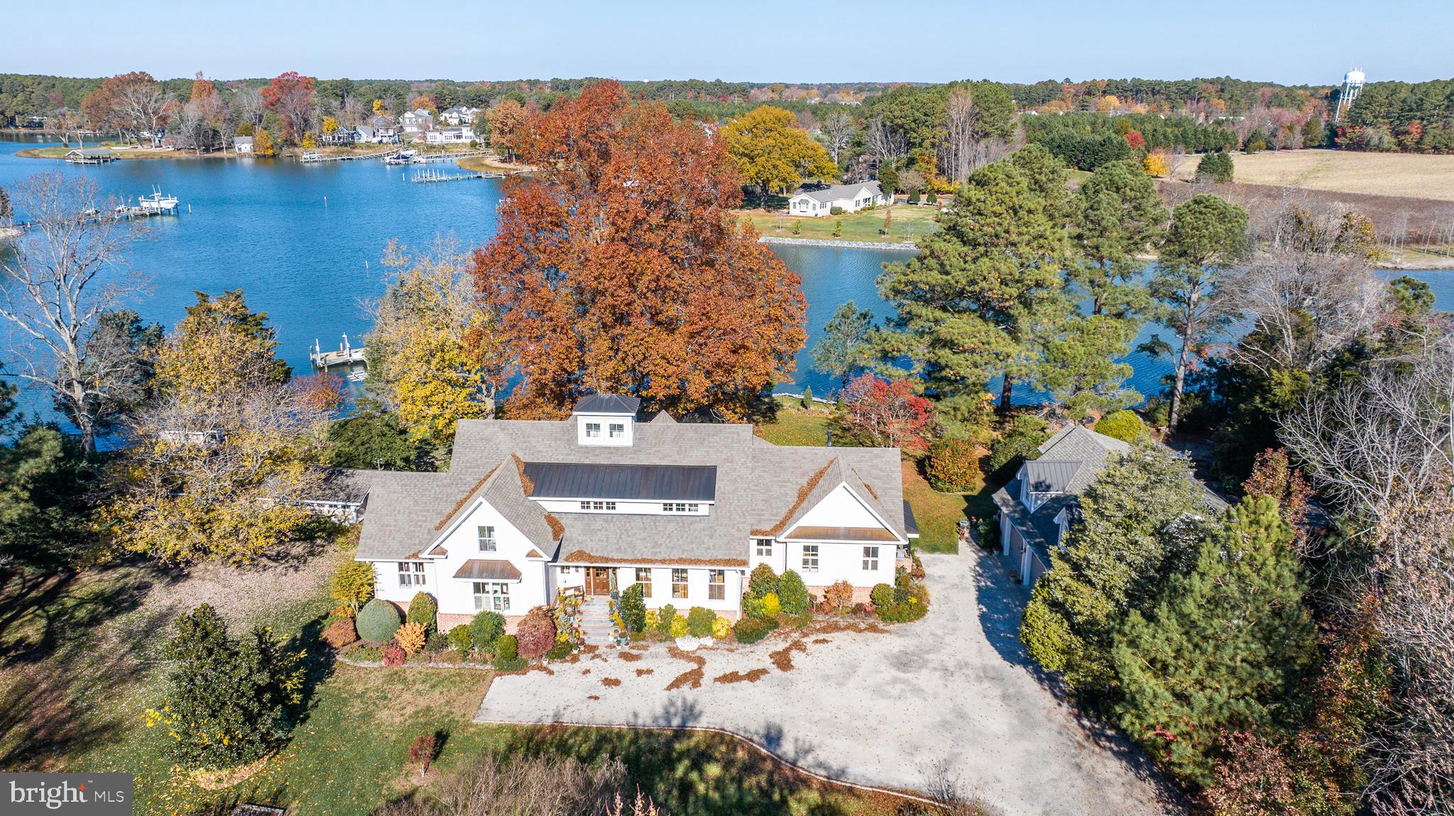 Welcome to your dream waterfront retreat! This custom-built masterpiece is a true gem, boasting unparalleled elegance and luxurious features. With 7 bedrooms and 5.5 ​bathrooms, this residence offers the perfect ​blend of comfort and sophistication. As you step inside, you'll be greeted by ​ample natural light that floods through the ​large windows, creating a warm and inviting ​atmosphere throughout the home. The ​cathedral-ceiling dining and living rooms add ​an extra touch of grandeur, providing a ​spacious and airy feel that is perfect for ​both entertaining and everyday living.

First floor primary suite with water views, custom walk-in closet, and a luxurious bath with heated floors, ​double vanities, relaxing jetted tub and beautifully tiled steam shower. The hardwood flooring adds a ​timeless and classic touch to the interior, complementing the high-end finishes and attention to detail that ​is evident in every corner of the home. The gourmet kitchen is a chef's delight, featuring stainless steel ​appliances and custom cabinetry.

For those who appreciate the finer things in life, this property also includes a detached 3-car garage with ​a 2-bedroom guest apartment, offering versatility and additional space for hosting friends and family. ​Imagine the convenience and luxury of having a separate space for guests to enjoy their privacy. Step ​outside, and you'll discover the guest cottage, a charming retreat overlooking the serene waterfront. ​With its own unique character, this cottage provides an ideal spot for guests or even a private home ​office.

The waterfront experience is taken to the next level with 250'+/- of rip-rapped shoreline, a private pier ​and boat lift. Whether you're an avid boater or simply enjoy the tranquil views of the water, this property ​offers the perfect setting to savor the beauty of waterfront living. Spend your days basking in the sun on ​your waterside deck, relaxing in your Swimspa, fishing off the pier, or taking a boat ride to explore the ​nearby waterways.  Immerse yourself in the beauty of nature and create lasting memories in a home that ​truly reflects your discerning taste. Don't miss the opportunity to make this gorgeous waterfront property ​your own!