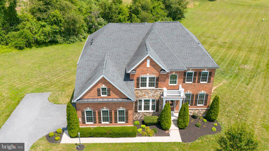 Rare opportunity to own a truly exceptional home in sought-after Pooledale Farm. Offering nearly 6,000 square feet of beautifully updated living space and breathtaking panoramic farm views, this custom residence seamlessly blends luxury, comfort, and functionality.

Thoughtfully redesigned by Worthington Home, the property showcases high-end finishes and sophisticated designer touches throughout. At the heart of the home is a stunning gourmet kitchen featuring a white Silk Quartzite waterfall island, full-height Quartzite backsplash, handcrafted graphite soapstone range hood, contemporary lighting, a new Wolf cooktop, and double wall ovens. Designed to impress, this space is equally suited for everyday living and entertaining on a grand scale.

Tons of luxury upgrades, including custom wood pantry shelving, heated bathroom floors, renovated bathrooms, enhanced theater room audio, and a beautifully finished lower level. The expansive basement offers versatile living space complete with a recreation area, guest suite, option, full bath, and private theater.

Step outside to a sprawling backyard retreat featuring a massive deck off the family room—perfect for hosting gatherings, enjoying sunsets, or simply taking in the serene countryside views.

Additional features include a whole-home sprinkler system, remote-controlled thermostats, and an intercom system throughout. Offering the tranquility of country living with the ideal layout for entertaining, this one-of-a-kind property delivers an unparalleled lifestyle in one of the area's most desirable communities.