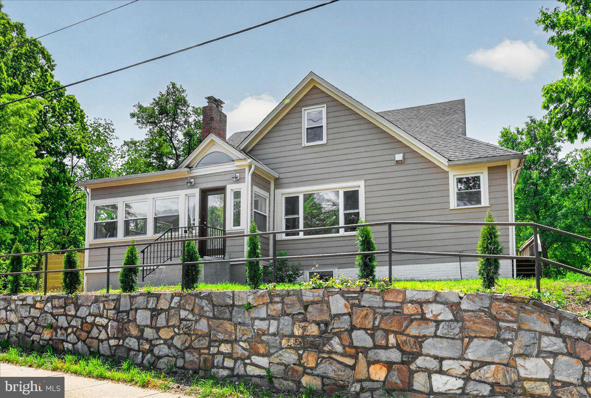 Welcome home to this beautifully updated Cape Cod, perfectly perched on an elevated 11,671 sq. ft. lot and thoughtfully designed for comfortable, flexible living. With 4 bedrooms and 3 full baths, this home blends timeless charm with modern upgrades in all the right ways.

Start your mornings or unwind in the evening on the sun-drenched porch, wrapped in windows on three sides—your own cozy retreat in every season. Inside, refinished hardwood floors flow throughout the main and upper levels, creating a warm and inviting atmosphere. The main level offers an effortless, open layout where the living and dining areas come together around a classic wood-burning fireplace—perfect for gatherings or quiet nights at home.

At the heart of the home is the stunning, fully upgraded kitchen featuring crisp white cabinetry, quartz countertops, and stainless-steel appliances—ideal for cooking, entertaining, and everyday living. Just off the kitchen, step out onto the back deck for seamless indoor-outdoor living. This level also includes two comfortable bedrooms and a spacious, fully upgraded full bath.

Upstairs, escape to your private primary suite retreat, occupying the entire level. Natural light pours in through two skylights, creating a bright and airy sanctuary. The fully upgraded, spa-inspired primary bath is a true showstopper, boasting a double vanity and a sleek glass-enclosed walk-in shower—designed for both luxury and relaxation—along with a generous walk-in closet.

The fully finished walkout basement offers incredible flexibility with its own private suite, including a legal bedroom,  fully upgraded glass-enclosed walk-in shower, and rec room. Whether used for extended family, guests, an au pair, or as a potential income-producing rental, this space easily adapts to your lifestyle.

Additional highlights include a lower-level laundry/utility room and a rare drive-through driveway accommodating 6–7 vehicles—perfect for hosting or multi-car households.

Ideally located for a connected, convenient lifestyle, you’re just minutes from Old Town Alexandria, Washington, DC, I-395, I-495, the Pentagon, Amazon HQ2, National Landing, Fort Ward, and a wide variety of dining and shopping options.

This isn’t just a home—it’s a lifestyle filled with comfort, flexibility, and everyday moments to enjoy.