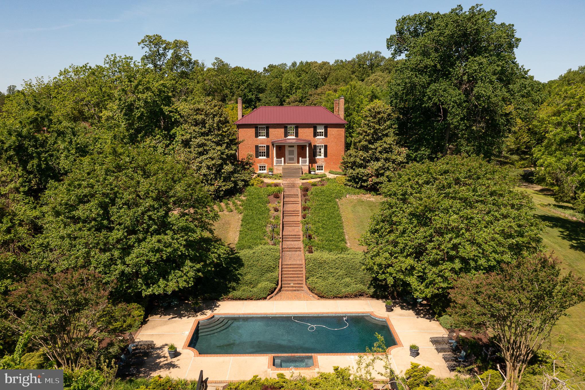 "LAVUE" Named for its spectacular view of 3 counties. Built in 1818 by George Alsop, Lavue is listed on the Virginia Landmarks Register.  The house and surrounding 60 acres are impeccably well kept.  The location is private yet very close to shopping at Cosner's Corner, the VRE station, and Spotsylvania Hospital.  

The original house is a typical antebellum four over four with a full basement.  The exterior walls are five bricks thick and a combination of Flemish bond on the front and American 5-course bond on the rear.  The hip roof is standing seam tin and was replaced in 2021 along with the heating system.  There are 4 chimneys with 3 fireplaces each, 2 have been converted to gas.  In 1834 an 'L' shaped addition was built.  The main house has a total of 3,400 SF of living space with 4 bedrooms, 3 full baths, and 1/2 bath.   The floors are original random-width heart pine.  There are massive pocket doors. The plaster walls have intricate stenciling believed to have been painted in 1830.   The English basement has slate flooring in the kitchen and the original brick floor in the bedroom area.  

In addition to the main house, there is a 2 bedroom guest house (with a good rental history, approximately 1,800 sf).  A 6 stall barn, several turn-out pastures, cleared trails, a well-stocked pond, equipment shed, and a gunite in-ground pool and pool house with changing room.  

The location, view, quality, condition, and amenities are a rare find!

Tax record is for the 10 acre parcel.  50 acre parcel is TM#37-A-41F

For the  buyer who is looking for all the amenities with the convenience this is a must to see!! And if you want a little less acreage - the owner is willing to consider selling a smaller parcel.