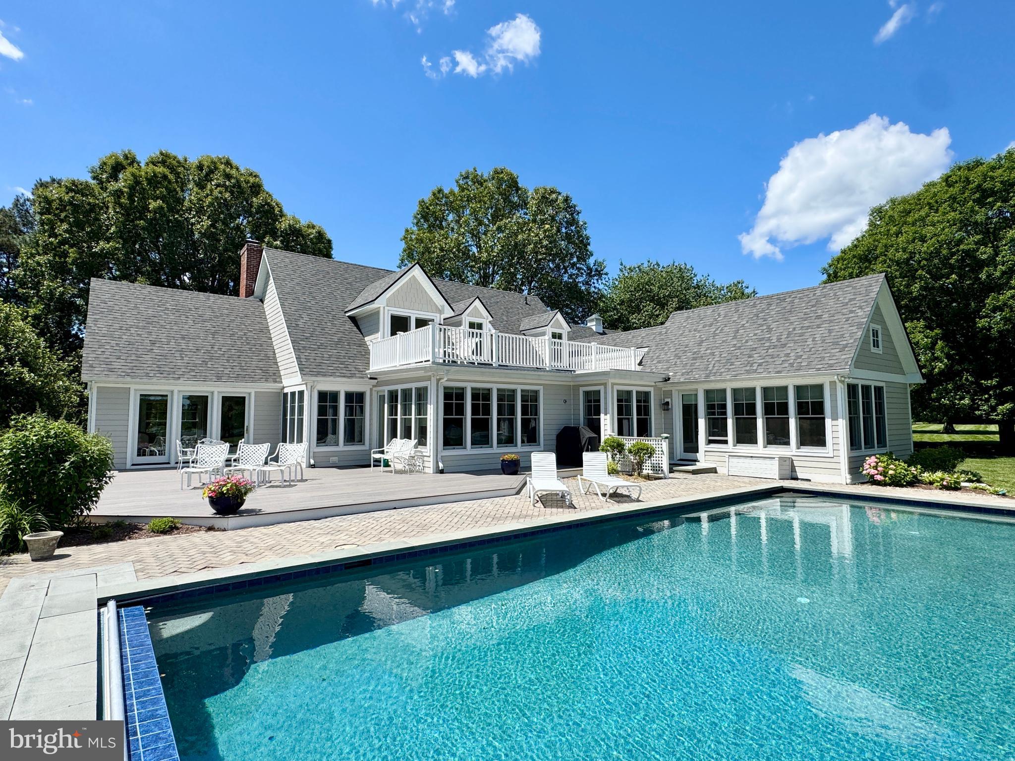 Discover the ultimate Eastern Shore retreat in the prestigious Baileys Neck community, just moments from Talbot Country Club. This exceptional waterfront estate sits on 5+ acres, offering breathtaking views of the river and a lifestyle of luxury and privacy. Recently renovated with  the addition of a primary bedroom wing in 2019 and a brand new roof May 2025 . The main residence features 5 bedrooms and 4 full bathrooms, including a first-floor primary suite with a private office and dedicated laundry room. Primary bath with air jet tub , separate shower and heated floors. The stunning open-concept kitchen has been completely remodeled, featuring high-end finishes, a walk-in pantry, and seamless flow for entertaining. Every bathroom has been beautifully renovated, and a second-floor balcony offers serene water views. A rare unfinished basement provides the perfect opportunity for a workshop, hobby space, or additional storage. Car enthusiasts will appreciate the attached two-car garage, along with a detached six-car garage that includes a separate workshop/office space with 1/2 bath and guest quarters  with full bath and kitchenette on the second floor. Outdoor living shines with a  new waterside pool built in 2016 , featuring a premium Pebble Tech  finish, creating a resort-like oasis.  Renovated in 2017 with additional bedroom and renovated bathrooms on 2nd floor, new wood floors, New HVAC, new kitchen, pantry, windows, siding,  garage doors, remodeled sunroom and modified fireplace.  2019 added primary bedroom wing, new BAT septic system, on demand hot water system, siding, and landscaping.  Enjoy boating, kayaking, and unforgettable views  from your private piece of the Shore. This extraordinary property blends elegance, craftsmanship, and unmatched amenities—don’t miss this rare opportunity to own a Baileys Neck waterfront gem.