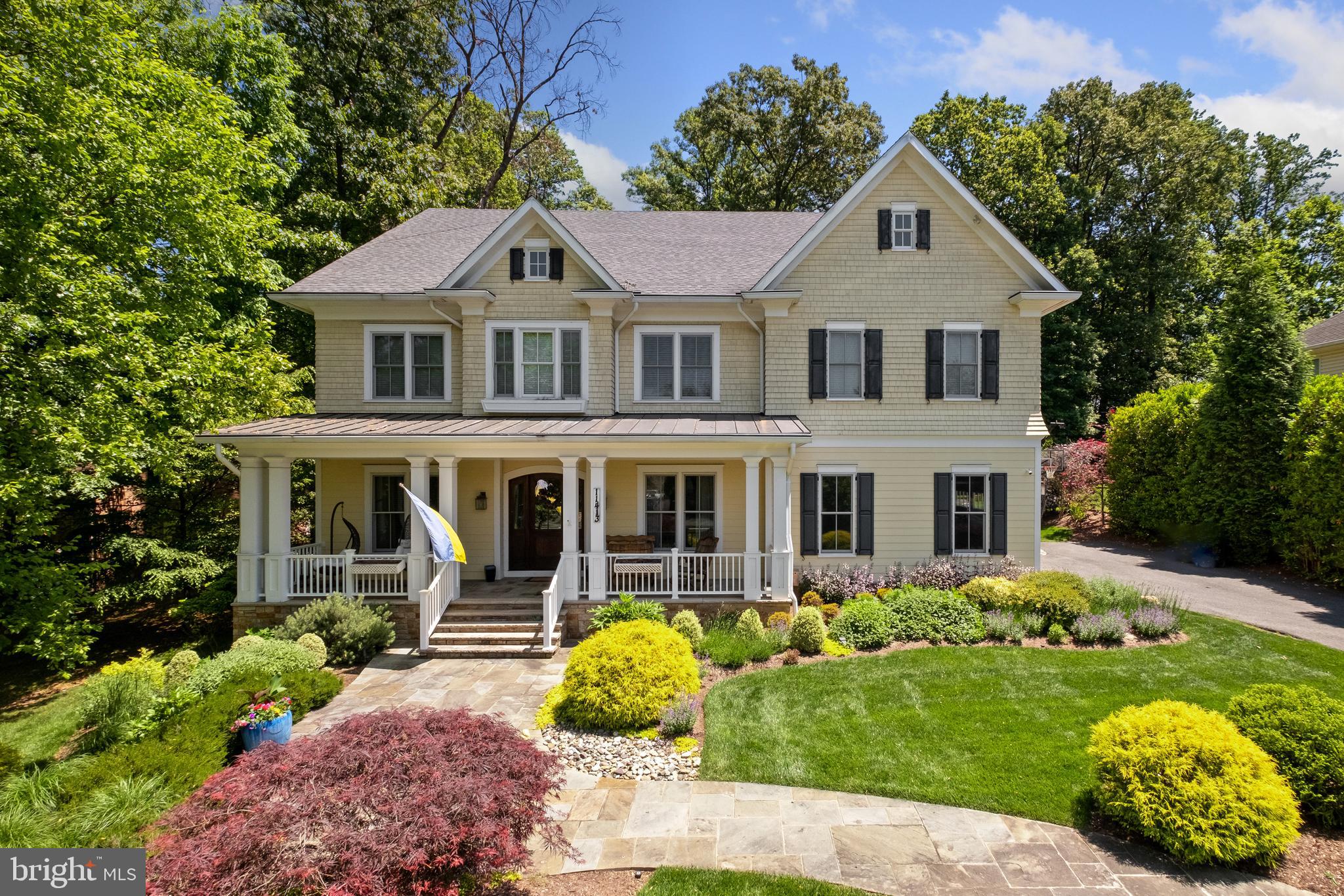 Welcome to 11413 Cushman Road, an exceptional Luxmanor estate distinguished by its refined craftsmanship, timeless architecture, and beautifully curated living spaces. Spanning four finished levels, this home balances sophisticated entertaining with the ease of everyday living.
From the moment you enter, a striking sense of scale and sophistication unfolds, defined by soaring coffered ceilings, custom window treatments, classic multi-pane windows, refined built-ins, and a dramatic stone fireplace that anchors the main living space. Sunlight pours through every room, enhancing the graceful flow and inviting atmosphere throughout.
Designed with entertaining in mind, the main level transitions seamlessly from the formal living room, equally suited as a private home office, into an expansive dining room ready for gatherings both large and intimate. At the center of the home, the chef’s kitchen serves as a natural gathering space, anchored by an impressive eleven-foot marble island and outfitted with premium appliances, including a Wolf stove, double ovens, and double dishwashers. A well-appointed butler’s pantry enhances both functionality and style, while an oversized two-car garage with additional storage and bike racks connects directly to a custom mudroom with built-in cabinetry designed for seamless everyday living.
Just beyond the kitchen, a spectacular sunroom addition framed by soaring atrium ceilings and dramatic walls of glass creates one of the home’s most captivating spaces. Filled with natural light, it offers the perfect setting for morning coffee, casual family dinners, or relaxed evenings overlooking the beautifully landscaped grounds.
Upstairs continues to impress with beautifully designed private spaces throughout. The primary suite is a true retreat, complete with a private balcony, expansive custom walk-in closet, and a secondary washer and dryer discreetly tucked away for added convenience. The spa-inspired bath features heated floors, a soaking tub, and an oversized shower.
The rare fourth-level addition creates a private retreat of its own, featuring an additional bedroom, full bath, and quiet study area ideal for guests, extended family, or work-from-home privacy.
On the lower level, expansive finished living spaces include a large recreation area, dedicated home gym, additional bedroom and full bath, and generous storage, offering exceptional flexibility for both everyday living and entertaining.
Outside, the beautifully landscaped grounds create a private outdoor setting designed for effortless indoor-outdoor living, complete with a relaxing cabana, built-in grill station, and mature landscaping that surrounds the property with seasonal color and natural beauty.
Powered by an energy-efficient geothermal heating and cooling system, this extraordinary six-bedroom residence seamlessly blends luxury, comfort, and modern efficiency in one of North Bethesda’s most coveted neighborhoods.