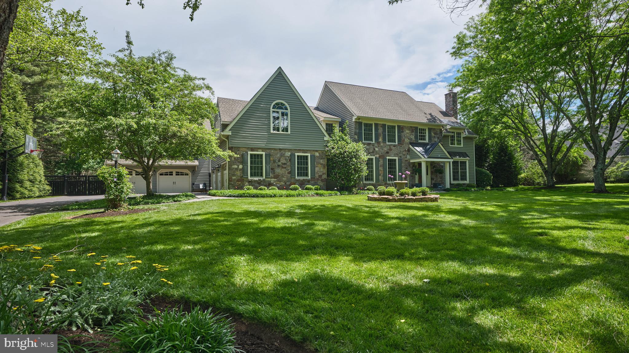 Welcome to the prestigious Buckingham neighborhood of Coldbrook, where winding tree-lined streets set the stage for this exceptional stone-front Colonial. Originally crafted by John Arrow Builders this wonderful home has been totally updated blending timeless elegance with modern comfort.  A bluestone walkway leads to the gracious covered portico. Inside, a dramatic two-story foyer with a turned wood staircase introduces the home’s classic architecture, refined millwork, hardwood flooring, and light-filled open layout. Formal living and dining rooms flank the foyer, flowing seamlessly into the home’s inviting gathering spaces. French doors open to a private first-floor study with custom built-ins.  At the heart of the home, the gourmet eat-in kitchen is designed to impress with custom cabinetry, quartz island and backsplash, custom gold brushed hardware and faucet, and premium stainless-steel appliances including a 6 burner Wolf professional range with double ovens, a Sub-Zero refrigerator, freezer and beverage cooler. The kitchen also features an adjacent organizational space that includes custom pantry built-ins. The adjacent breakfast area is adorned with custom built-ins and is overlooking the resort-style outdoor living areas and wooded backdrop. The cozy family room showcases a floor-to-ceiling stone fireplace with raised hearth and direct patio access.  A generously sized laundry room and half bath complete the first floor. Upstairs, the luxurious owner’s suite offers 2 professionally organized walk-in closets and spa-inspired bath complete with free standing soaking tub, seamless glass shower, radiant heated floors, double bowl custom vanities, and private water closet. Four additional generously sized bedrooms that includes a renovated “Jack and Jill”  bathroom and a generous sized hall bath.  The finished lower level expands the home’s entertainment possibilities with flex spaces ideal for gaming, fitness, or hobbies, and abundant storage. As an added bonus there is a detached 2 car garage with large private office. Outdoor living is equally spectacular, featuring a sparkling pool and spa surrounded by lush landscaping, expansive patio, fire pit and pool cabana. Beyond the property, a wooded trail connects directly to Maplewood Park and continues into historic Doylestown, where charming shops, acclaimed dining, and cultural attractions await. Ideally located with convenient access to New York, Princeton, and Philadelphia, and situated within the award-winning Central Bucks School District, this extraordinary property offers luxury living in one of Bucks County’s most coveted communities.