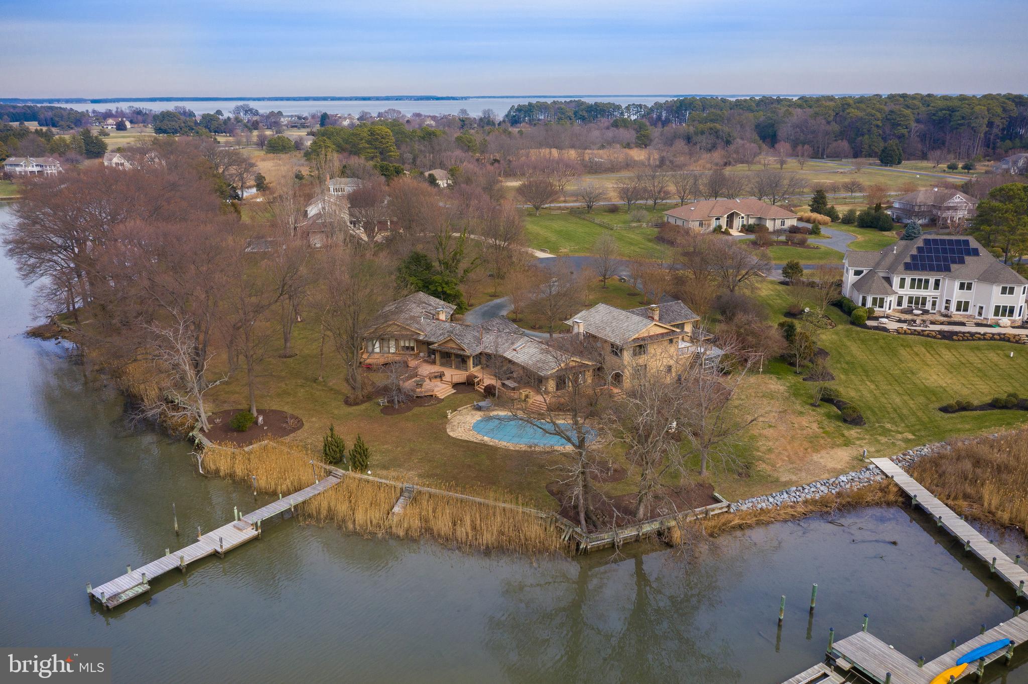 Tranquility at its best with 180-degree waterfront & views! This home was designed to take advantage of the views, on a one of a kind waterfront lot.  Quality lives here with Cedar Shake roof, a Green House, Pool, Art studio, 4 en suite bedrooms, Library, 3 plus garages & much more! Wonderful, free flowing house that is set-up to entertain or the ability to live long term, on one level.  A little something, something for everyone! The Exposure is Westerly, with sunsets that will provide you a different scenic view, every night full of color.  Wind protected waterway with big views, and the luxury of a community Marina for almost any size boat. If you are not a boater, and want the best of K.I. with tennis courts, golf course, private beach, club house and more, this is the community for you. Ten mile drive to the base of bay bridge.Virtual Tour Link   https://thru-the-lens-ivuf.view.property/1522272?idx=1Aerial Tour Link   https://player.vimeo.com/external/388262197.hd.mp4?s=3849856a694df3103dff485baaa5722d34962843&profile_id=175