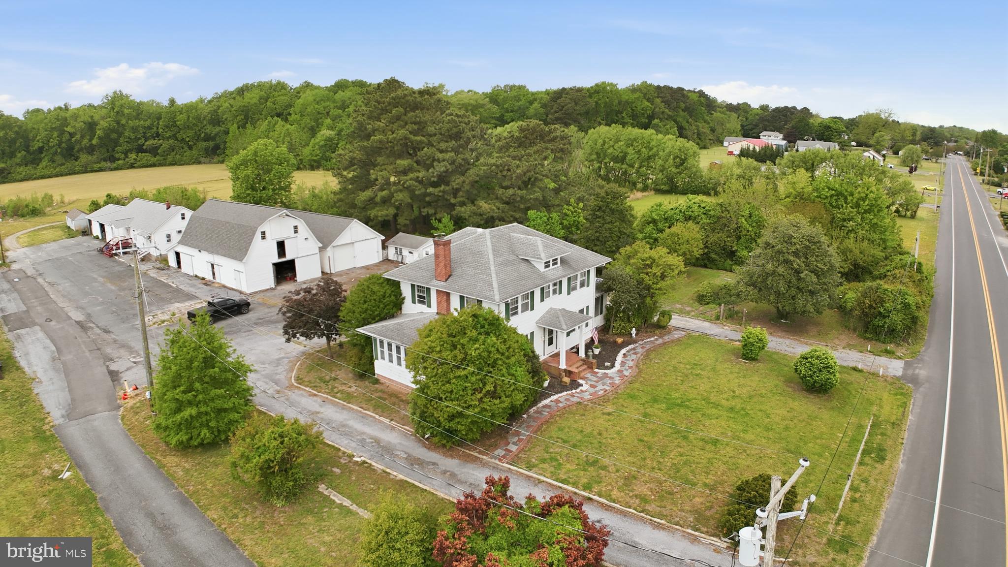 Discover the perfect blend of lifestyle and livelihood on this versatile 5+ acre estate, ideally situated with easy access to Route 13. At the heart of the property sits a charming three-bedroom, two-bathroom farmhouse that seamlessly pairs classic style with modern comforts, featuring updated bathrooms, fresh kitchen flooring, and two bright sunrooms perfect for relaxing.
The grounds are a rare find for those seeking residential, business, or agricultural opportunities. Professional amenities include a dedicated office space and a functional four-bay building, while the agricultural structures—a large two-story barn with 3–4 stalls and a spacious tractor barn—both boast brand-new roofs. Currently holding a conditional use permit for a psychiatry office, this property offers incredible potential, though any new specialized use will require County protocol approval. Whether you're looking to launch a boutique farm, a home-based business, or simply enjoy a sprawling private retreat, this unique property is ready for its next chapter.