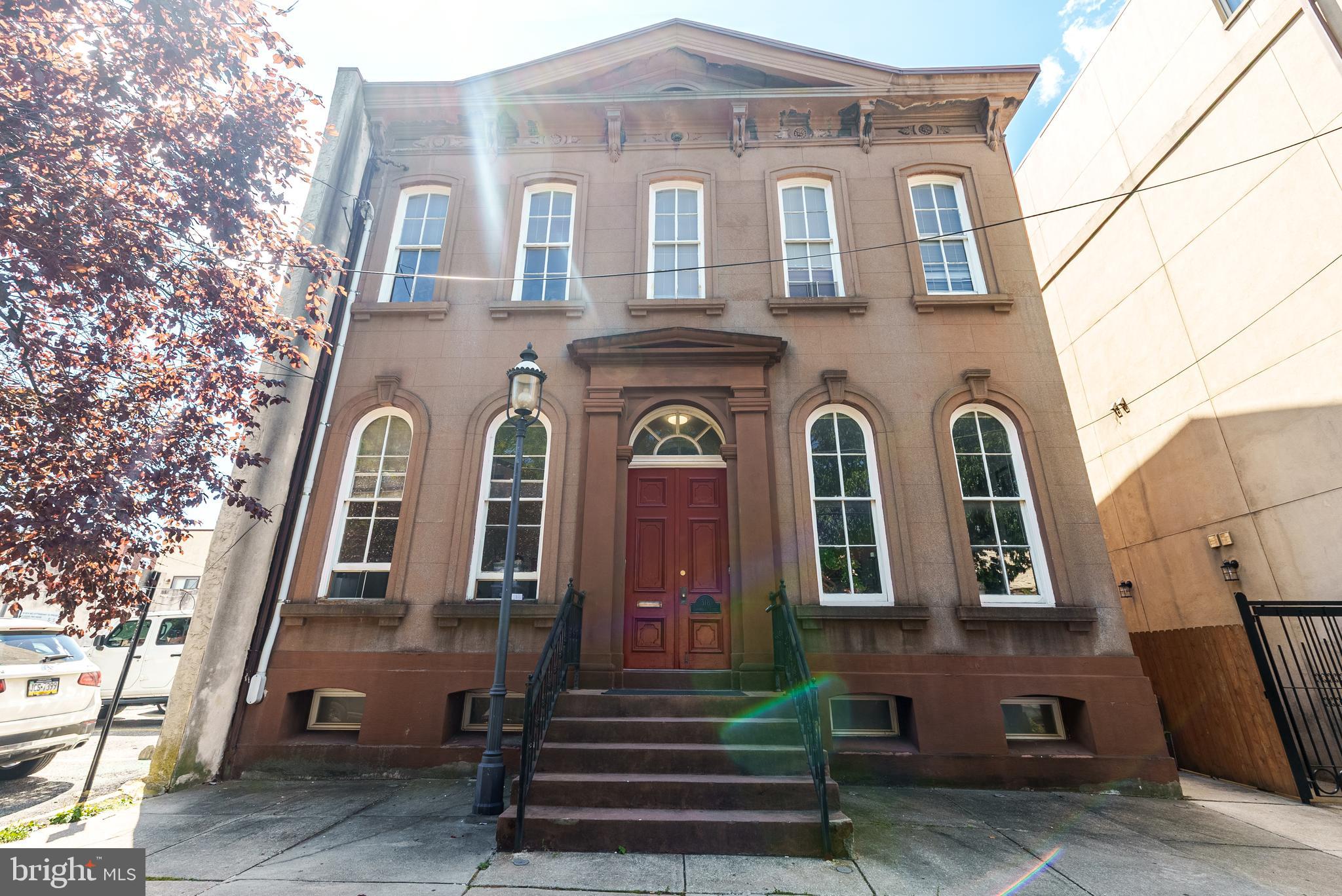 MOTIVATED SELLER! 318-20 Bainbridge St. - Double Wide Nestled in the heart of Queen Village, within the esteemed Meredith School catchment, lies a truly unique and rarely offered brownstone building, spanning an impressive 40x110 feet. This architectural gem, dating back to circa 1840, is a testament to timeless elegance and charm. With the space for expansion/construction, the property boasts an enormous, country-like landscaped garden (40x55/2100 sq ft) WOW! Unheard of in the city! This magnificent building houses three fabulous apartments, each offering a distinct living experience with modern comforts and historical charm. Unit A: The Penthouse unit, sized at 1,700 square feet, features three bedrooms and two bathrooms. It is a spacious retreat boasting expansive living spaces, perfect for those who enjoy luxury and comfort. With its high ceilings and floor-to-ceiling windows, natural light floods the rooms, highlighting the beautifully refinished original hardwood floors. Unit B: offers a stylish bilevel layout that maximizes space and functionality, with a size of 1,000 square feet, two bedrooms, and two bathrooms. This unit is ideal for those seeking a cozy yet sophisticated environment, complete with charming architectural details and modern amenities. Unit C: combines elegance and convenience in its expansive bi-level design, offering 1,500 square feet with two bedrooms and two bathrooms. Perfect for entertaining or relaxing, this unit features sizable bedrooms, a cook’s kitchen, and a spa-like bath that offers a luxurious retreat. Each unit within this brownstone has a spectacular view of Bainbridge Green Park and the enormous rear garden in addition to being a showcase of gorgeous details and thoughtful design. Original hardwood floors are expertly refinished to preserve historical integrity, and high ceilings enhance the sense of space and grandeur. Floor-to-ceiling windows allow for an abundance of natural light. Gorgeous cooks kitchens and spa baths are designed for modern living and comfort. Detailed woodwork and fireplaces add warmth and character, while exposed brick and private balconies offer a unique blend of urban and rustic charm. This extraordinary building offers incredible amounts of space and numerous possibilities. Keep it as a triplex for rental income, convert it to condos for investment opportunities, transform it into a single-family mansion, live in one unit and rent the others for additional income, or convert back to a commercial office space very easily. With its exceptional location and unmatched character, this brownstone is a rare gem in Queen Village. Whether as an investment or a personal residence, it promises a lifestyle of elegance and convenience. Don’t miss the chance to own a piece of history in one of the city's most sought-after neighborhoods.