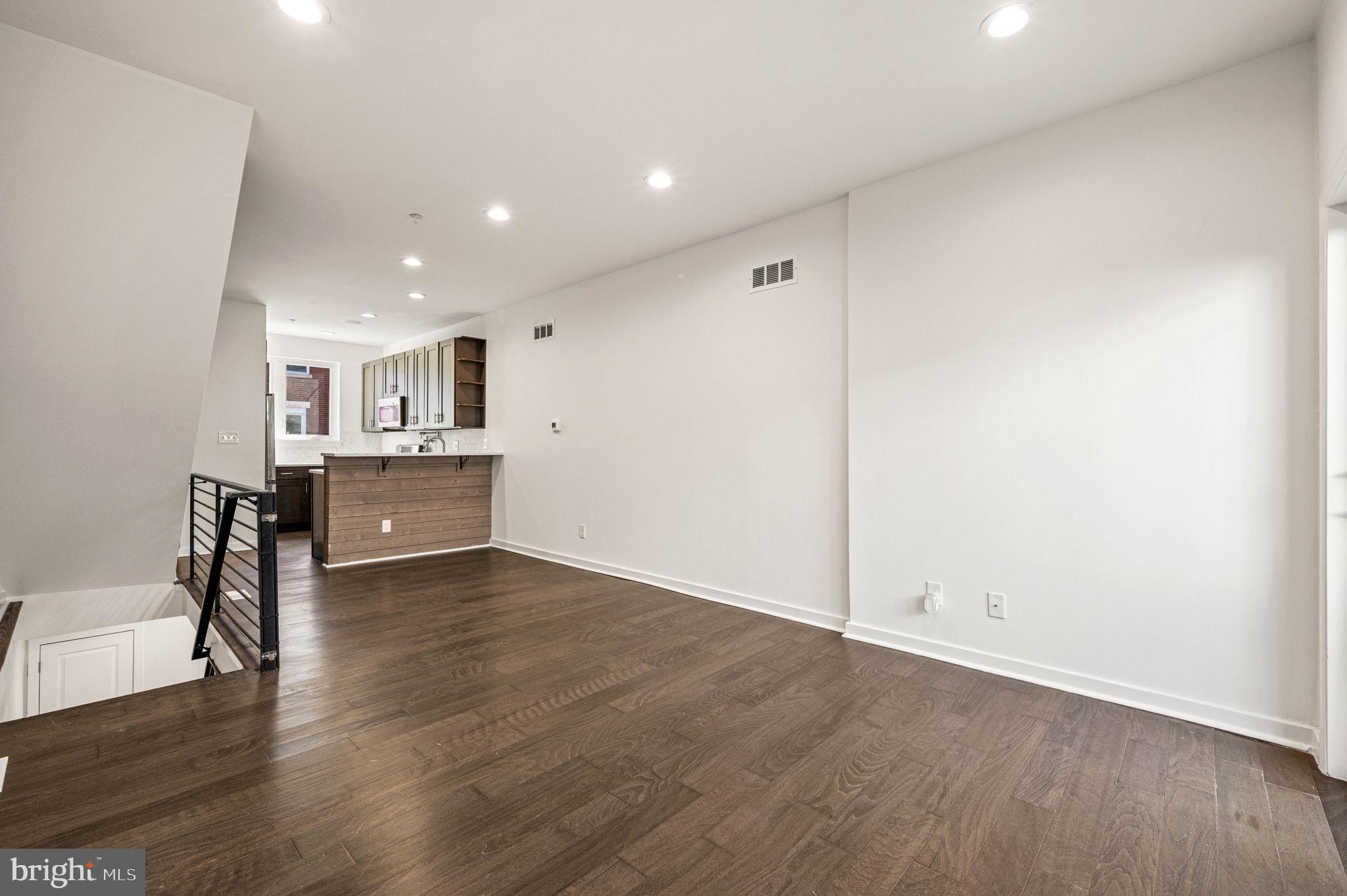 Welcome to 2045 Watkins Street, a beautifully crafted newer-construction townhome in Philadelphia’s vibrant Point Breeze neighborhood. Built in 2021 and offering approximately five years remaining on the tax abatement, this exceptional residence combines modern design, thoughtful upgrades, and everyday comfort.

Spanning three levels plus a fully finished basement, the home features 3 bedrooms, 2 full bathrooms, and 1 half bathroom. The open-concept main level is designed for both entertaining and daily living, showcasing wide-plank flooring, sleek modern railings, recessed lighting, and a stunning chef’s kitchen complete with stainless steel appliances. The kitchen flows seamlessly into the bright and inviting living area, where a built-in whole-house speaker system creates the perfect atmosphere for gatherings. A gas line concealed behind the living room wall provides an easy opportunity to add a fireplace and further enhance the space. Just beyond, a private concrete patio offers the ideal setting for outdoor dining, relaxing, or hosting guests.

The finished lower level expands the home’s living space with a versatile family room, media room, home office, or playroom, along with a laundry area, convenient half bathroom, and additional storage.

The second floor features two generously sized bedrooms with ample closet space and a well-appointed full bathroom. Occupying the entire third floor, the luxurious primary suite serves as a private retreat, offering expansive closets and a spa-inspired bathroom complete with double vanities and heated floors for year-round comfort.

A pilot house leads to the show-stopping roof deck, where sweeping views of the Center City skyline create the perfect backdrop for entertaining or unwinding. A convenient wet bar on the third floor adds another thoughtful touch for hosting family and friends.

Ideally located just south of Graduate Hospital and minutes from Rittenhouse Square, this home places you within easy reach of some of Philadelphia’s finest dining, shopping, parks, and entertainment.

Modern, stylish, and truly move-in ready, 2045 Watkins Street offers the best of contemporary city living.