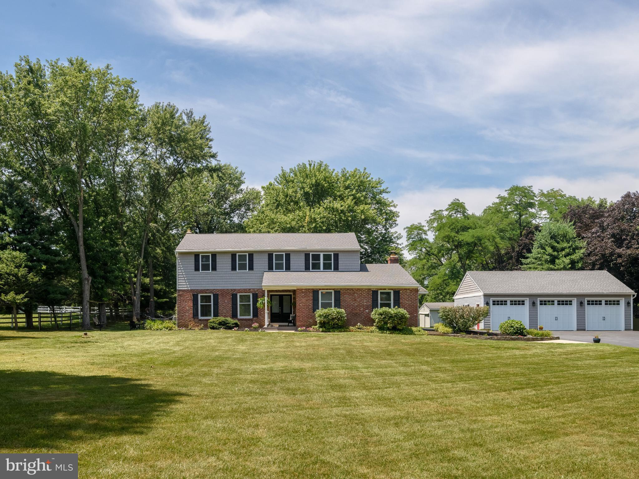 Welcome to 31 Glen Manor Lane, tucked away in a quiet Glenmoore neighborhood in historic Chester County. Lovingly maintained by the same owners for over 40 years, this beautiful Colonial welcomes you with a charming covered front porch, timeless curb appeal, two level acres, and a thoughtfully designed floor plan—including a private main-level in-law suite—that offers the space and flexibility to fit every stage of life. Step inside to a welcoming foyer hallway that opens to a spacious living room with hardwood floors, an inviting space for quiet evenings, holiday gatherings, or catching up with friends. Toward the back, the kitchen and dining area become the heart of the home, where weeknight dinners, homework at the table, and celebrations naturally unfold. Thoughtfully designed for both everyday living and entertaining, the kitchen features stainless steel appliances, abundant cabinet and countertop space, a built-in wet bar for your morning coffee or evening glass of wine, and windows overlooking the backyard. Sliding doors from the dining area lead directly to the spacious composite deck, making it easy to enjoy meals and gatherings outdoors. Just off the kitchen, a step-down family room centers around a wood-burning fireplace with reclaimed brick surround, creating a warm and comfortable place to unwind. Through a set of center-set French doors, the sunroom is filled with natural light from nearly floor-to-ceiling windows and offers sweeping views of the backyard. Whether you're enjoying your morning coffee, reading a book, or hosting friends, this room is sure to become a favorite. A sliding door opens to the deck, while a second exterior door provides convenient access to the driveway. The main level also offers a private in-law suite with its own entrance from the driveway, making it an exceptional space for multi-generational living or extended guests. Complete with a bedroom, full bath, generous living area, dining nook, cabinetry/refrigerator and abundant closet space, it provides comfort and independence without sacrificing connection to the rest of the home. A powder room, and mudroom with laundry and side entrance complete the first floor. Upstairs, the primary suite serves as a relaxing retreat with beautiful craftsman-style millwork, a walk-in closet, and an en-suite bath. Three additional generously sized bedrooms share a full hall bath, while pull-down attic access provides even more storage. The partially finished basement adds another level of versatility with a built-in bar and sink, powder room, and unfinished space for storage, hobbies, or a workshop. Outside, two level acres (both cleared and wooded) invite you to spread out and enjoy the seasons. There's plenty of room for backyard games, gardening, entertaining, or simply taking in the peaceful surroundings. A partially fenced yard adds flexibility, while the oversized detached three-car garage with 9-foot garage doors and built-in shelving, along with a storage shed/barn with stalls, provides exceptional space for vehicles, tools, equipment and hobbies. Located in one of Chester County's most desirable areas, you'll enjoy the tranquility of country living while remaining just minutes from the center of Downingtown, Marsh Creek State Park, shopping, dining, local farm markets, schools and major commuter routes (322, 82, 30). For more than 40 years, 31 Glen Manor Lane has been lovingly cared for by one family, with four generations creating memories within its walls. Now, this special home is ready for its next owners to begin a new chapter. If you've been searching for a home with character, exceptional flexibility, and room to make it your own, this is one you won't want to miss!