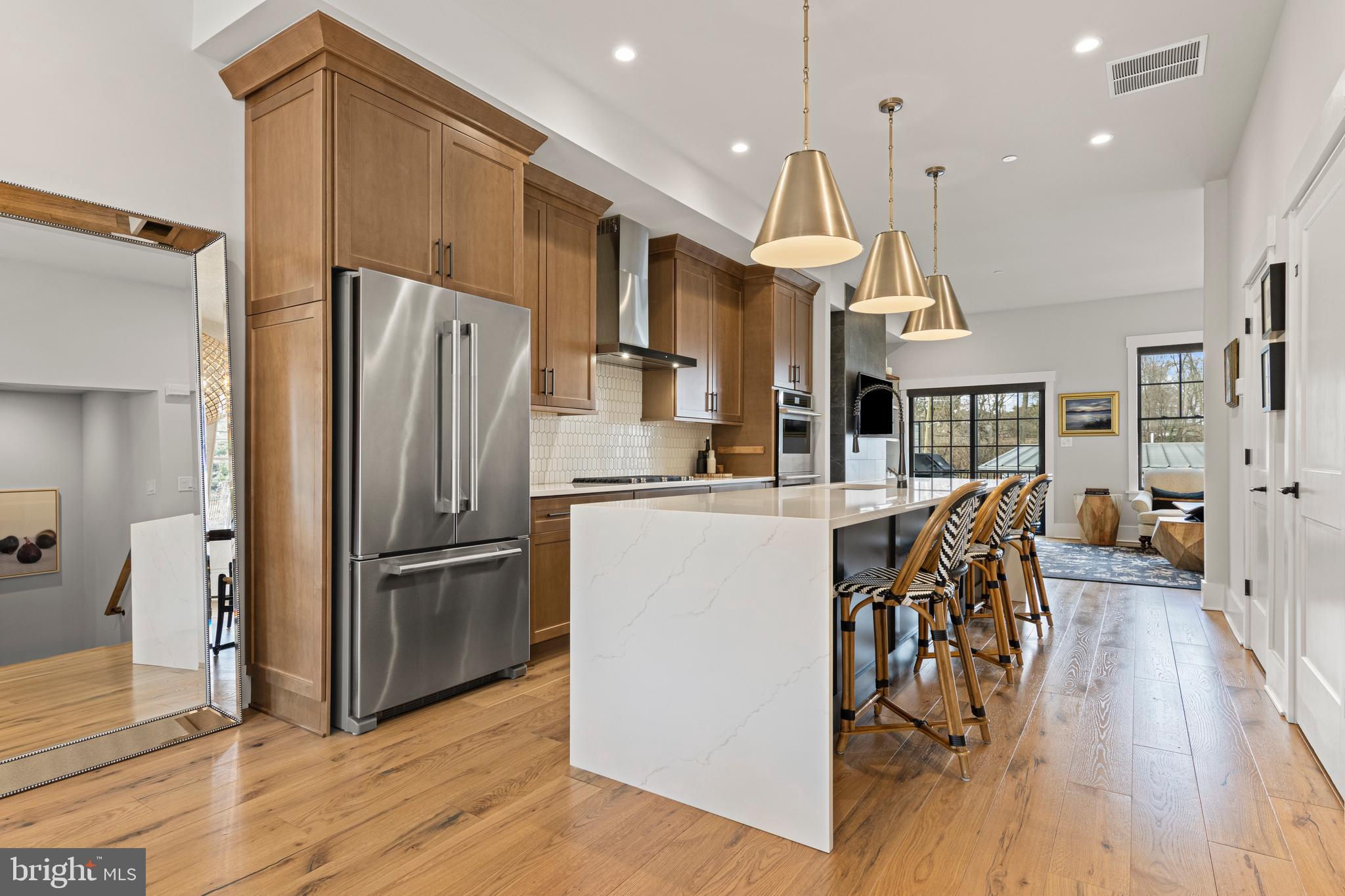 206 N Aberdeen Ave, Unit C offers a greatly sought-after "Walk-to-Wayne" lifestyle in an exceptional, nearly-new luxury resale at Rockwell on Aberdeen. Built in 2022 by Rockwell Custom Home Builders, this exclusive 6-townhome enclave provides the pinnacle of low-maintenance living in the heart of Radnor Township. Unit C distinguishes itself with high-end custom finishes across four finished levels, featuring the added convenience of a private 3-stop elevator serving the lower level, main floor, and primary suite level.
The main level welcomes you with an airy, open-concept floor plan featuring rich solid wood floors, 10-foot ceilings, and beautiful solid wood interior doors throughout. The sun-drenched dining area, anchored by a gorgeous statement chandelier, flows seamlessly into the gourmet kitchen. A true showstopper, the kitchen features an extra-large waterfall quartz island with a deep undermount sink, handsome wood cabinetry, gorgeous tile backsplash and a premium JennAir stainless steel appliance package including a double wall oven. Beautiful designer pendant lighting and recessed lighting illuminate the space, which leads into a spacious Great Room centered around a sleek natural gas fireplace with floating wood shelves on either side. Through black-framed sliding doors, enjoy a private composite deck with privacy walls—an ideal retreat for morning coffee or evening relaxation.
The second floor serves as a dedicated sanctuary accessible by both stairs and elevator. The luxurious Primary Suite is outfitted with hardwood floors, elegant crown molding, and two walk-in closets with custom shelving. Its spa-like ensuite bath offers dual vanities and a large glass-enclosed shower with a dual-head system. Also on this level is a spacious second bedroom with its own hall bath featuring a bathtub, and a conveniently located laundry area.
Continuing upstairs, the third-floor loft provides incredible versatility as a third bedroom, home office, or media room, complete with its own full bathroom and bonus living space.
The finished lower level (also served by the elevator) is outfitted with durable luxury vinyl flooring and provides a highly functional layout including a private home office, a bonus room space, and a powder room. This level also provides direct access to the attached rear-entry garage. Modern systems include 4-zone natural gas HVAC for precision comfort on every floor.
Located in the top-ranked Radnor Township School District, this property is just 0.5 miles from the Wayne Train Station, providing direct service to Philadelphia and NYC via Amtrak. Commuting is made easy as Route 30 provides quick access to I-476, with major corporate centers nearby in Radnor. Conveniently located in Wayne, you are minutes from iconic local dining like Rosalie, The Goat’s Beard, and Christopher’s, as well as popular shops including Best Hardware, Gingy’s, and Ballard Designs. This central location is perfectly situated close to neighboring Main Line towns including Villanova, Bryn Mawr, and Berwyn. From the nearby Strafford Farmers Market to the scenic Radnor Trail and the luxury shopping at King of Prussia, everything is within reach. Don't miss this rare opportunity for modern luxury in the heart of the Main Line.