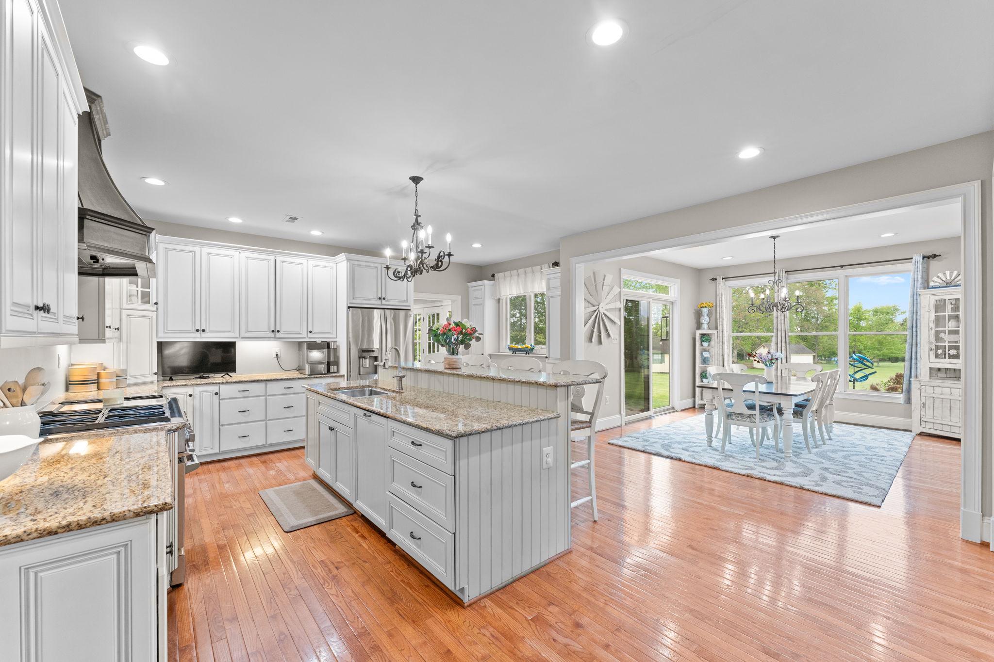 Welcome HOME to 912 Ashbourne Way!  Offered at a new price and nestled in the highly sought-after Ashbourne Estates, this stunning Colonial blends luxury, comfort, and everyday livability across more than 4,400 square feet of beautifully designed space. From the moment you step into the grand foyer, the home feels warm, welcoming, and made for both entertaining the most sophisticated events to everyday relaxing and enjoyment.  
The dining room is perfect for hosting gatherings, featuring a gorgeous tray ceiling and a full butler’s pantry with a wet bar and dishwasher for added convenience. The gourmet kitchen is truly the heart of the home, complete with high-end appliances, a commercial-grade side-by-side oven, a striking dark copper hood, and an abundance of granite countertop space. The oversized two-tier island makes entertaining effortless while still being ideal for everyday meals.
The open floor plan flows seamlessly into the spacious family room and expansive casual dining area designed to comfortably accomodate large gatherings and everyday living.  Surrounded with views of the open yard and in proximity to the kitchen so the chef never misses out on the conversation. The family room features brand-new carpet and a beautiful natural stone fireplace that creates the perfect cozy atmosphere. Looking for a quieter retreat? The formal living room offers oversized windows with private, peaceful wooded views. Just off the living room is a fifth bedroom with its own bath, making it an ideal setup for an in-law suite or private guest suite.  
Upstairs, you’ll find four more generously sized bedrooms, including an incredible primary suite designed to feel like a true retreat. Enjoy a large sitting room, two separate walk-in closets, and a luxurious primary bath featuring two private commodes, a dual entry shower, built-in vanity, and a soaking tub all surrounded by tons of natural light. Two additional bedrooms share a Jack and Jill bathroom while  overlooking the expansive backyard.  The 4th bedroom is such a unique delight boasting a hand crafted coastal mural in it's generous space while also containing its own private full bath.
Need even more room? The finished bonus room over the garage offers endless possibilities and even has room to add another full bathroom for an additional en suite. The sizeable upstairs laundry room adds convenience with extra storage and countertop space. A rear staircase leads down to the mudroom, complete with built-ins, two closets, and a second powder room with easy access to the garage, kitchen or the front of the home. 
The unfinished basement offers an incredible amount of storage and plenty of flexibility for a future gym, hobby room, or finished living space customized to your prefrences. 
Outside, the 1.84-acre lot provides a private, serene setting with a flat backyard perfect for entertaining, play, or simply relaxing. Enjoy evenings on the expansive paver patio or unwind in the hot tub while taking in the peaceful backyard oasis. Utilize the pole barn shed for the exterior maintenence items and leave the 3 car garage for parking your vehicles!  The long driveway provides ample parking and a great space for outdoor basketball! No need to worry about big ticket items.  This home has had a new roof, new garage doors, new grinder pump and a new water heater all in the last few years.  912 Ashbourne truly offers the perfect blend of luxury and comfort, with thoughtful details and versatile spaces throughout. Schedule your private showing today and make it your new home!!