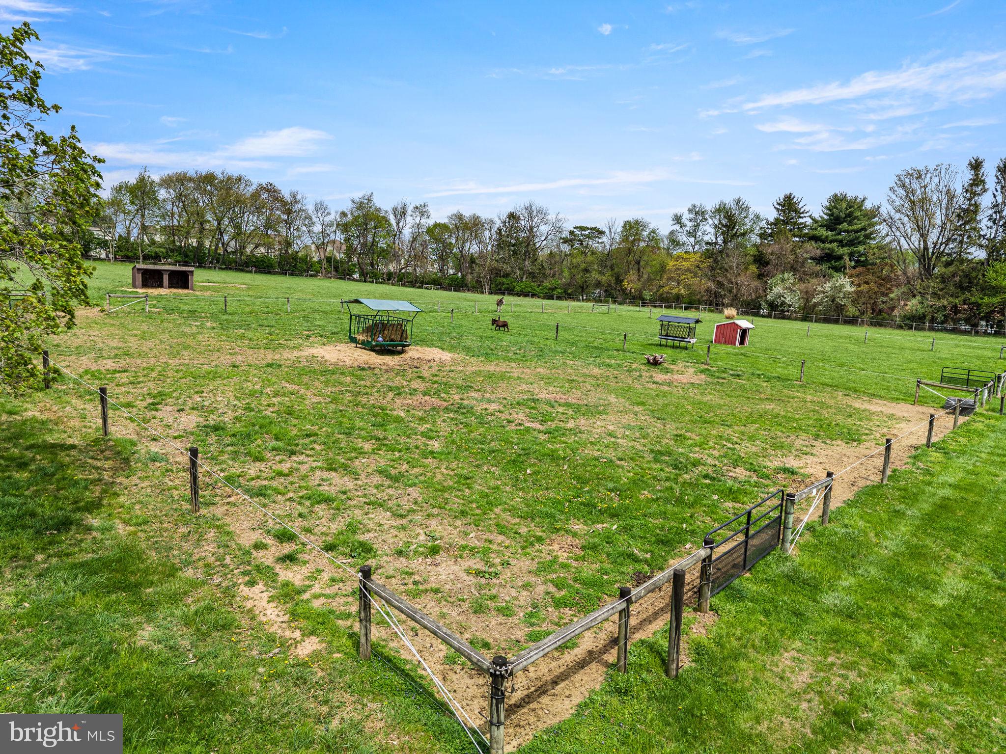 Welcome to 1725 Goosetown Road, a rare and exceptional offering in the heart of East Fallowfield Township, Chester County. This tranquil 58+ acre property features two homes, a workshop, and four well-fenced horse pastures equipped with water, along with open meadows, wooded riding trails, tillable acreage, and a secluded, spring-fed, fully stocked pond. The two-bedroom, one-and-a-half-bath main house offers a rustic log-style interior with both original wood accents and thoughtfully incorporated reclaimed barn wood, creating a warm and inviting atmosphere. The home has been renovated with tremendous care and intention, blending unique vintage touches with modern conveniences throughout. At the heart of the home is a true chef’s kitchen, featuring a commercial-grade 48-inch JennAir gas range with double ovens, a pot filler, wine fridge and new cabinetry with soft-close drawers, all complemented by concrete countertops.
From the dining area, French doors open onto a patio that is perfect for morning coffee accompanied by birdsong, grilling with the family or a glass of wine while taking in the spectacular sunsets.  The main house has been thoughtfully updated with a metal roof, new windows, a propane heating system, a new well pump, and the addition of a tankless on-demand water heater—all within the last two years—ensuring efficiency and peace of mind. With all major systems already addressed, only a few cosmetic finishing touches remain.  
The property also includes a three-bedroom, one-bath guest house. This residence was fully updated just two years ago with a new metal roof, new windows, updated kitchen and cabinetry, fresh paint, and new flooring. Additional amenities include a 600 sq. ft. heated and air-conditioned garage/shop, along with an RV pad offering electric, septic, and water hookups. Three separate electric meters service the main house, guest house and RV pad/garage. Whether you’re an equestrian, nature lover or outdoor enthusiast, this property offers an exceptional lifestyle. For those who enjoy hunting, the peaceful landscape provides an ideal setting for scouting and harvesting trophy bucks. The privacy is unmatched. Perfectly positioned for both privacy and convenience, the property is located just 3 miles from the SEPTA Thorndale train station and offers easy access to major travel routes, Coatesville Airport, as well as nearby shopping, restaurants and banking. While the property lends itself beautifully to a private country estate, family compound or horse farm, it also represents a compelling investment opportunity. All building rights remain intact, offering significant potential for future development or subdivision. With multiple access points, favorable zoning, and proximity to growing retail and commuter hubs, this is a rare opportunity to create a thoughtfully designed residential community in a serene, natural setting. The property also includes an existing barn structure with 6 stalls and room for more that may offer future potential depending on the buyer’s vision. Please note, the property consists of eight separate tax parcels and is being sold as one. It is also enrolled in Act 319 (Clean and Green program), which provides significantly reduced property taxes. The listing agent must accompany all showings, and buyers are required to provide proof of funds or pre-approval. There is no sign at the property, and it is located at the end of a long driveway. Access is not permitted without the listing agent present. Please be respectful.