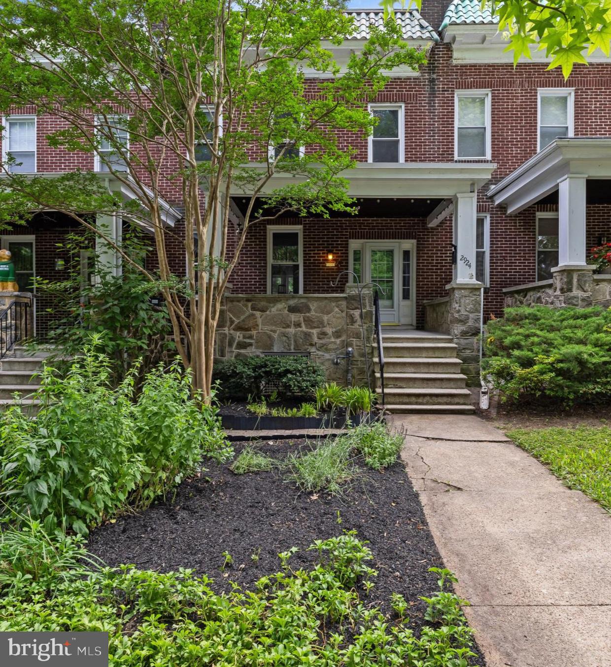 How would you like to live right across the street from Johns Hopkins University? Located on the quiet, and tree lined Wyman Parkway, this beautiful brick-and-stone porch-front home features 3 large bedrooms, 2 full baths, with parking pad for one, blending classic character and extensive updates over the life of this ownership.

The main level offers a spacious living room and formal dining room with both with custom built-ins shelves, leading to a refreshed galley kitchen with new cabinets, quartz countertops, large format vinyl tile, and premium appliances ('24–'26). Just off the primary bedroom is a large dressing room and closet, perfect for a home office or future ensuite. Storage is abundant throughout, including a large kitchen pantry, a foyer coat closet, a huge upper-hallway walk-in closet, plus, large utility room with basement walkout perfect for bikes and gardening equipment.

The owner invested well and carefully maintained this home for just over two decades. 2924 offers total peace of mind with updated Romex wiring throughout, copper/CPVC plumbing, replacement windows, a renovated second-floor bath, added a full basement bath, installed an energy efficient “indirect water heater,” and a well-maintained roof. Outside, you’ll find a beautifully landscaped front yard with perennials that attract pollinators.  And did we tell you there is a parking pad for one?  Enjoy an unbeatable location that’s steps from JHU, the BMA, the Wyman Park Dell, and just minutes to dining and fun in Charles Village, Hampden, and Remington.  Come make 2924 Wyman Parkway Your Home!