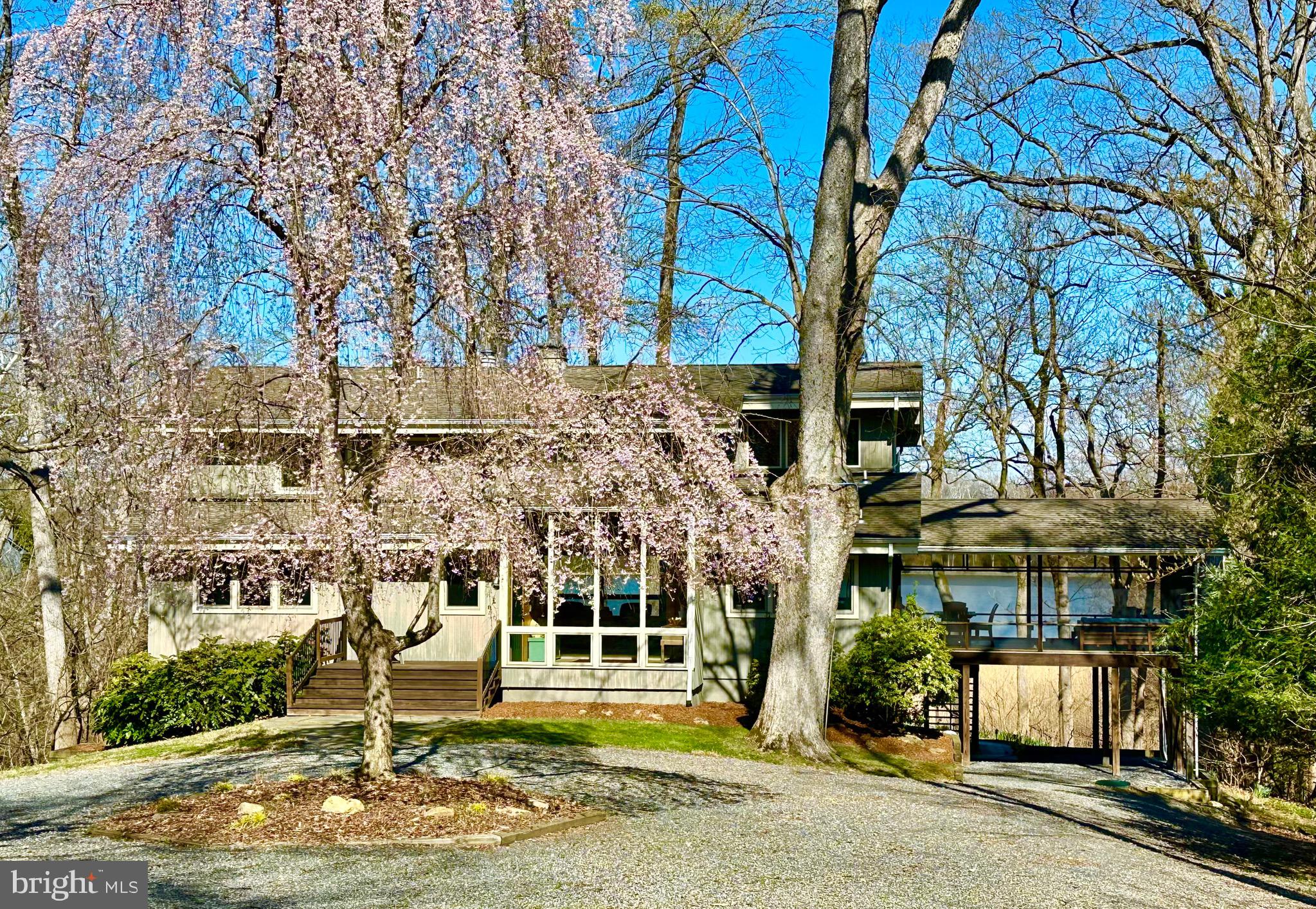Waterfront living overlooking Still Pond Creek! Gently nestled into the woods on 5.67 acres of peace and nature, this special home is the ultimate dream getaway for relaxation and recreation. Enter this very private sanctuary surrounded by nature which offers a large, circular area accommodating parking for many guests. Upon entering the home, you will take in the elevated waterfront views from the light-filled great room with a soaring ceiling and a wall of windows. This space opens to a deck as well as a large screened-in porch that is the heart of the home all summer. It features a seating area to spend hours relaxing and enjoying the sounds of nature in complete privacy, and a dining table to watch the changing colors of the sky every evening. The open floor plan of the home is ideal for entertaining and offers waterfront views from nearly every room. The home features three bedrooms, three full baths, a loft office, a wood-burning fireplace, and a walk-out lower-level area with additional guest space and recreation area, including one of the full baths and additional large storage areas. Upstairs the primary suite is very private, with a renovated bath and beautiful water views. The home has many upgrades throughout, including beautiful hardwood decking on the decks and porch and new two-zone heating and cooling.  The property is surrounded by a native pawpaw patch, and each summer you will await the arrival of the many zebra swallowtail butterflies they host.  In the morning, wake to a beautiful sunrise over the creek, and listen to the many songbirds that pass through the property. The nearby eagle nest often leads to seeing them soaring overhead. At the waterfront there is a private sand beach where no other homes can be seen in any direction. Sunset is also a special time to sit down on the dock and enjoy the evenings. Stone steps lead down the path to the dock and water, first over a short raised boardwalk and then through a magical moss section, arriving at the private pier with a 8000lb boat lift, electricity, and approximately 4.0 ft MLW. Still Pond Creek, ideal for kayaking, fishing, boating, paddle boarding, wake boarding, and more, makes this a water lover’s dream home. The location is ideal - just around the corner from the bay yet just beyond the section frequented by those coming to experience the charm and deep anchorage of the creek. Located in the highly sought-after community of Kinnaird’s Point with a community boat launch, beach, and pavilion, high-speed internet, and located just outside of Chestertown - 59 miles to Annapolis, 87 miles to DC, and 86 miles to Philadelphia. Historic Chestertown on the Chester River, home of Washington College, is located just 10 miles away and offers great restaurants, bars, shopping, an outdoor Farmer’s Market, annual celebrations including the Chestertown Tea Party, Sultana Downrigging Festival, and much more. Please do not drive in the driveway without an appointment. The property is available furnished, excluding art and personal items. The structure sits well above the water and is not in a flood zone. Full home, septic, and water reports available online.  Owner is a licensed PA realtor.