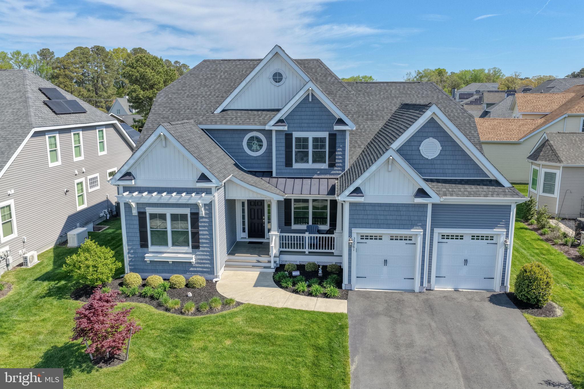 Welcome to this stunning pond-front Coastal Craftsman in the highly sought-after Solitudes on Whites Creek community. Built in 2018 and thoughtfully designed for both everyday living and entertaining, this spacious 5-bedroom, 3-bath home offers the perfect blend of comfort, function, and outdoor enjoyment.

The main level features four bedrooms, including a beautifully appointed primary suite, along with hardwood flooring throughout the main living areas and hallways. A bright, open-concept layout showcases cathedral ceilings, a great room with a gas fireplace, and a white gourmet kitchen complete with a large island and adjacent dining area. A  sunroom offers additional living space with serene pond views, while a custom wet bar enhances the home’s entertaining appeal.

Convenience meets practicality with a mudroom and main-level laundry, plus a 2-car garage with a 4-foot bump-out for extra storage.

Upstairs, you’ll find a private retreat featuring a fifth bedroom, full bath, and a huge recreation room—ideal for guests, a media space, or multi-generational living—along with a large unfinished storage area. A separate HVAC system services the second floor for added efficiency and comfort. 

Step outside to your own backyard oasis, where extensive two-level hardscaping overlooks the pond. Enjoy evenings around the built-in fire pit, relax on the front porch, or rinse off after a beach day in the outdoor shower. An irrigation system keeps the landscaping lush and low maintenance.

Located in a waterfront community offering amenities including a pool, recreational facility, fire pit, Tiki bar, grilling area, kayak launch, beach area,  boat ramp, and pier/dock access, this home delivers the best of coastal living.