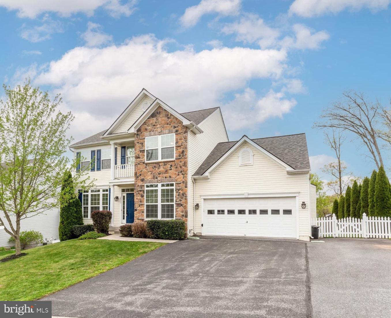 Motivated Sellers! Located in the desirable Manchester Farms neighborhood, this move-in ready home offers space, flexibility, and thoughtful updates throughout. Hardwood flooring spans the main level, where you’ll find a private office/library at the front of the home and a family room with vaulted ceilings and a fireplace just off the kitchen. The spacious eat-in kitchen opens to a trex deck with a retractable awning, overlooking a beautifully landscaped, fenced backyard and a gorgeous paver patio—perfect for everyday living and outdoor entertaining. Upstairs features four generously sized bedrooms with brand new carpet, including a primary suite with vaulted ceilings and a private en-suite bath, along with an additional full hall bath. The finished lower level adds even more versatility with a handicap-accessible in-law suite, complete with a full bath, living area, and a kitchen setup—ideal for multigenerational living or extended stays. Recent updates include a new roof (2023), tankless water heater (2023), and all new kitchen appliances on the main level. An extended driveway provides ample parking and space for a camper or recreational vehicles. No HOA!