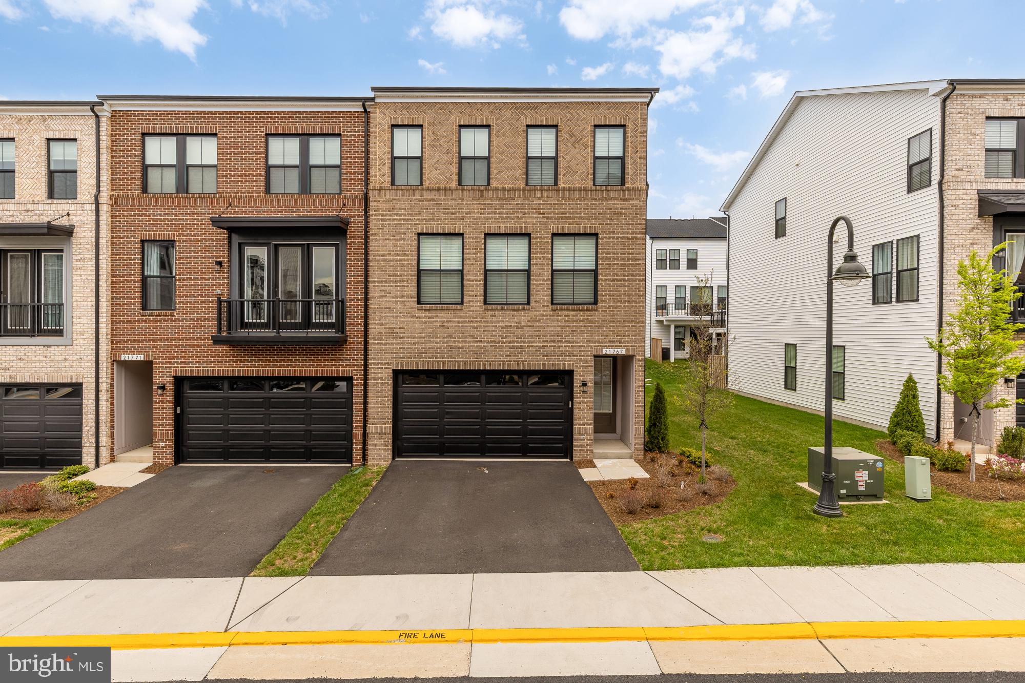 Introducing a refined residence in the sought-after Dollis Hills community.

Built in 2024, this stunning 3-bedroom, 2 full and 2 half-bath home offers 9-foot ceilings, luxury plank flooring, and a bright, open-concept design that feels both elevated and inviting.

The main level is centered around a show-stopping kitchen, the true heart of the home which features quartz countertops, high-end stainless steel appliances, sleek cabinetry, a designer backsplash, and an oversized island that seats up to five. On one side, enjoy a cozy living room with a fireplace; on the other, step out to your private balcony with elevated views.

Upstairs, the primary suite offers a spacious walk-in closet and a beautifully appointed en-suite with dual vanities and a walk-in shower with built-in seating. Two additional bedrooms are generously sized with ample storage.

Resort-style amenities include a clubhouse, fitness center, outdoor pool, tennis courts, and playground—bringing convenience and lifestyle together in one community.

Two car garage.