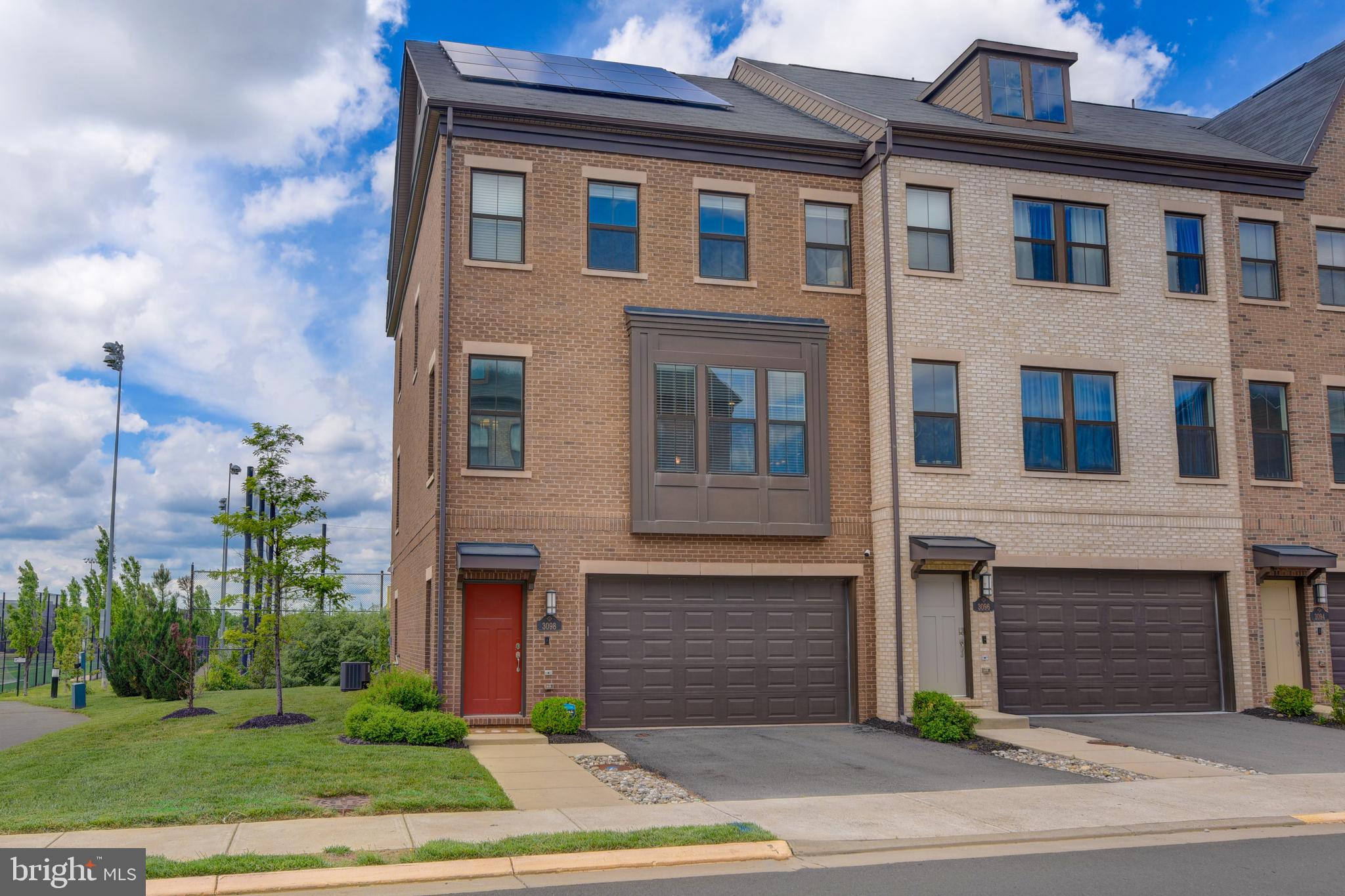 Rare East Facing End-Unit Townhome in Discovery Square — Nearly 3,000 Sq Ft with Rooftop Deck and Park Views!

Step into this beautifully maintained, four-level end-unit townhome in sought-after Discovery Square — a rare opportunity,  built in 2018 and lovingly cared for.  With just under 3,000 sq ft of finished living space, this home offers an expansive open layout, privacy, and unbeatable views of the Sully Highlands athletic fields. Better than new with amazing updates, including a fully paid-for rooftop solar energy system, finished garage, and "smart" blinds & lights.

Inside, you'll find four legal bedrooms, four full bathrooms, and a main-level half-bath — including a true fourth bedroom with its own full bath on the top floor, a unique upgrade in this community. The ground floor provides flexible space for a home office, gym, or media room, complete with hardwood floors and walk-out access to green space.

The heart of the home is a light-filled main level featuring gleaming hardwoods, a spacious living area, and a stunning gourmet kitchen with white cabinets, crown molding to the ceiling, stainless steel appliances, and a built-in cold brew coffee maker in the fridge (yes, really — caffeine on demand!). Enjoy sunsets from the deck off the kitchen or host friends on the oversized rooftop patio.

The primary suite offers a spa-inspired bathroom with a frameless glass shower, dual sinks, and a generous walk-in closet. Conveniently, your laundry is located upstairs near the bedrooms.

A rare two-car garage and two-car driveway provide room for four vehicles — a major perk in this neighborhood — with guest parking just steps away. Best of all, the HOA handles all lawn and landscaping, so you can skip the yard work and enjoy the amenities.

Bordering Sully Highlands Park and just minutes from Dulles Airport, the Udvar-Hazy Air & Space Museum, the future Metro Silver Line extension, and Reston Town Center. Quick access to Route 28, the Toll Road, and Fairfax County Parkway. Nearby top-rated schools including Floris Elementary, Rachel Carson Middle, Westfield High and the prestigious Nysmith School for the Gifted.

Don’t miss your chance to own one of Discovery Square’s finest — schedule your showing today!