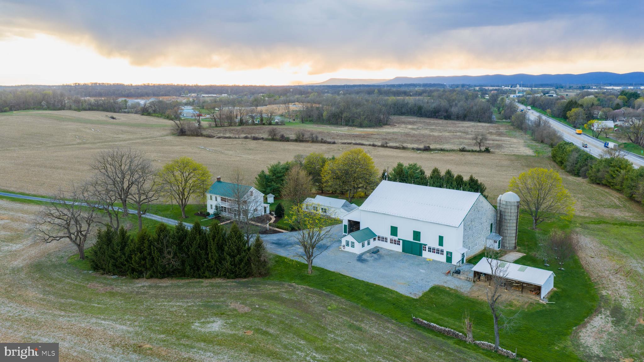 Tucked behind rolling tillable fields in Silver Spring Township, this 80.14-acre farm is the kind of place that stops you mid-sentence. Two parcels. Two entrances — one off W Trindle Road, one off North Locust Point Road. Eighty acres of some of the highest-producing soils in Cumberland County, currently under a $10,000 annual tillable lease that puts money back in your pocket while the land does what it was always meant to do.

The farmhouse dates to 1860 but has been meticulously restored. Not renovated, not remodeled, but restored. Designed into an extensively thought-out vision that honors every original detail while bringing the home to modern standards. Original hardwood floors. Exposed chestnut log walls. Hand-hewn ceiling beams. A stone walk-in fireplace that anchors the main level. And every system behind those walls is brand new — plumbing, electric, HVAC, windows — all brought to current building codes without sacrificing a single ounce of character.

The kitchen alone will take your breath away. Solid cherry custom cabinetry. A Wolf range. Sub-Zero refrigerator and freezer. An imported farmhouse sink. Custom hardware crafted by artisans in Lancaster County and Massachusetts. Built-in appliances. Amish-built details throughout. Butler's pantry. Gourmet island. This is not a kitchen — it is a statement.

Three bedrooms. Three bathrooms. 2,649 square feet across two stories with a partially finished basement, interior and exterior access, and a stone foundation that has held this home for over 160 years. Highly desired and a stand to test and time, James Hardie siding. A standing seam metal roof. Period-correct exterior detailing. Recessed lighting. Walk-in closets. Upper floor laundry. Central air. Every thoughtful upgrade you could ask for — already done.

Step outside and the views will hold you there. Sweeping, uninterrupted sightlines across manicured grounds, open fields, and a landscape that changes with every season. If you think of life when things were much simpler, this home has the porch and balcony to reminisce on. 

The 1860 stone bank barn has been professionally repointed and stands as a centerpiece of this property — a working piece of history that most people only see in photographs in magazines.

This property is protected under a conservation easement as well as neighboring properties preserving the peaceful landscape for lifetimes to come. Through the Clean & Green Program, taxes remain low while the easement preserves its agricultural legacy while still allowing for a second home on a designated 2-acre building envelope. 

Professional architectural renditions are available for buyers with a vision to expand the residence. A new well has been installed. Extensive hardscape, exterior lighting, patios, porches, and a stone driveway complete the setting. This home is beyond turn key, its the portal to life you've been awaiting.

Located in the Cumberland Valley School District, minutes from Carlisle and Mechanicsburg, with easy access to I-76, Baltimore, Washington D.C., and Philadelphia. Privacy and convenience — in the same sentence. Staple stores and restaurants are a stone throw away while you feel secluded in serenity of your own.

Properties like this don't come on the market often. They come along once and you either recognize it or you don't. Immaculate. Manicured. Private. Protected. Eighty acres of legacy farmland with world-class soils, a meticulously restored home with luxury upgrades and no expense spared, and a stone barn that has stood since before the Civil War.

This is not just a listing. This is your next chapter. Welcome to the best part of your story.