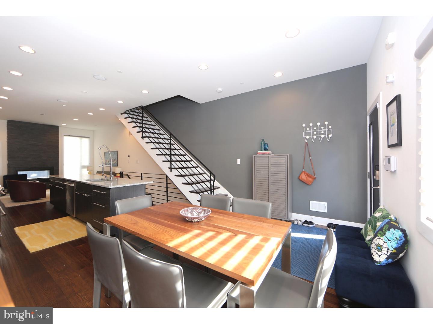 Welcome to your better than new construction home in Fishtown's most sought after block. 1215.5 Day St is the epitome of smart, modern living with thoughtful design, quality craftsmanship and stellar amenities that are in a class of their own.  Enter the first floor where you will find a generous open concept design plan flowing between dining, living and kitchen areas that are all bathed in natural light from the large windows on the east and west sides. The chef's kitchen is appointed with high end finishes throughout including GE Cafe Series stainless steel appliances, an expansive granite countertop and warm custom cabinetry. Notice the gorgeously tiled fireplace in the living area - an added dimension that can also be enjoyed outside in a gracious backyard area perfect for entertaining or relaxing. Two full sized bedrooms can be found on the second floor, each with abundant closet space. The second floor is thoughtfully equipped with laundry room, full bath that includes a double vanity, bath/shower and meticulously crafted tile and details. Step up to the third floor owner's suite level complete with a sitting area, a full bath equipped with double vanity, beautifully tiled large shower, gorgeous custom hardwood shelving and private appointment. Full walk-in custom closet and private balcony which leads up to the green roof; captivating river, bridges and skyline views included. Full and finished basement with more than ample storage and closet space and a full bath. Perfect as a home office/work area, media room, bedroom etc. This gem also includes one car park, modern clad brick and stucco facade, heavy duty and carefree green roof along with the best location in one of Philadelphia's most coveted neighborhoods. Included and lavishly equipped with Sonos  Sound System, dual HVAC/Nest  temperature controls and beautiful Hunter Douglas  window treatments throughout. With a Walk Score of 96, this urban sanctuary offers the best in location and city living with 7 years left to take advantage of the tax abatement. Open House Sunday October 15th 12pm-2pm