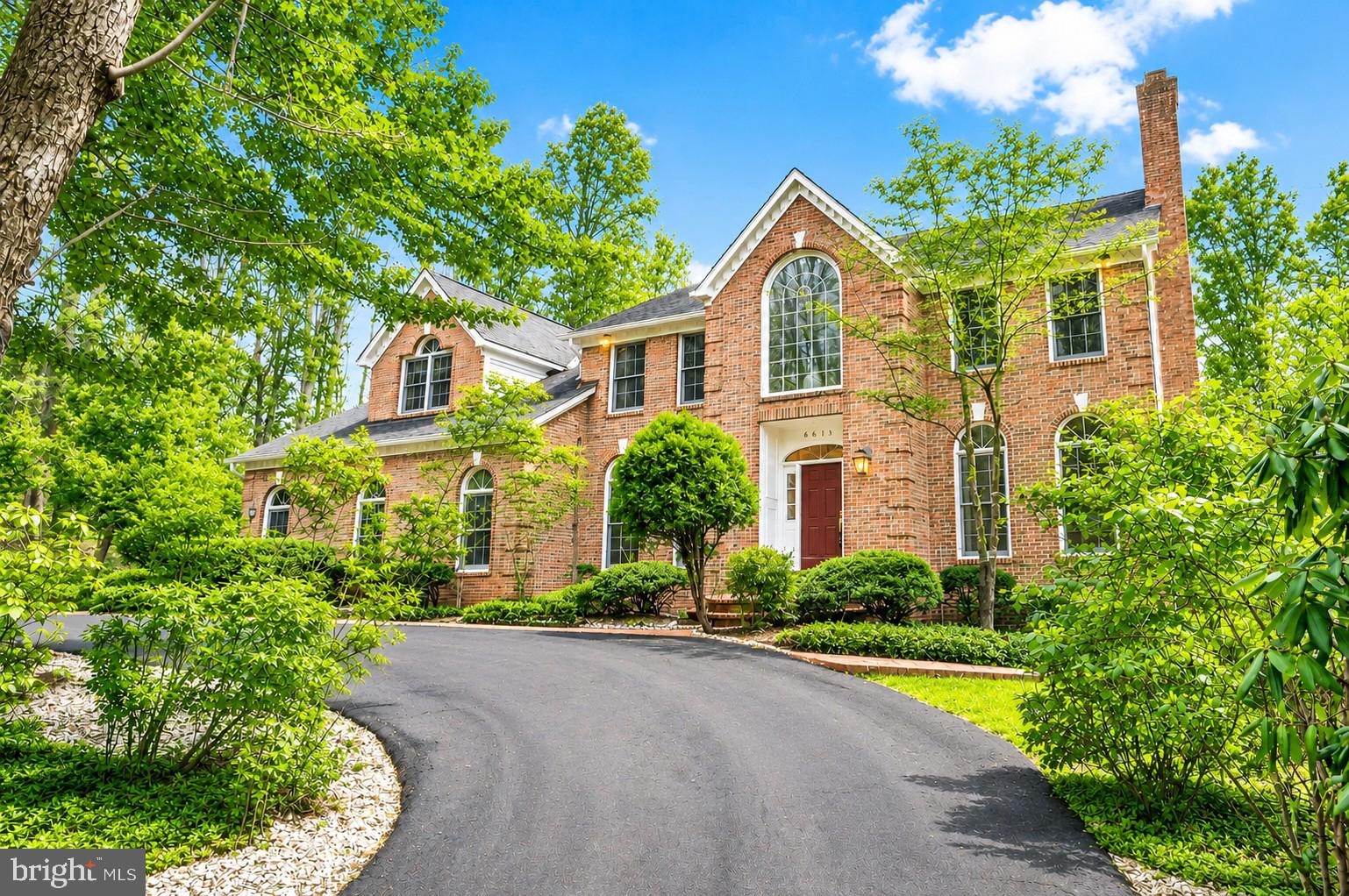 An exceptional opportunity - seller is prepared to consider all reasonable offers! Your chance awaits to own one of Clifton’s most distinguished estate homes. This extraordinary 7,400 sq ft all‑brick residence offers 5 bedrooms, 5.5 bathrooms, and an unmatched blend of luxury, privacy, and tranquility—just minutes from major amenities and the timeless charm of historic Clifton.

A dramatic two‑story foyer sets the stage with a grand crystal chandelier, sweeping circular staircase, exquisite woodwork, and extensive custom moldings that immediately convey refined sophistication. The formal living and dining rooms are gracious in scale and beautifully appointed, with expansive windows framing picturesque views of the surrounding landscape.

Just beyond the living room, a light‑filled private study provides an ideal retreat for work or quiet reflection, enhanced by an elegant chandelier imported from the Czech Republic.

At the heart of the home, the expansive family room features a striking stone wood‑burning fireplace and a well‑appointed wet bar—perfect for entertaining. Flowing seamlessly from this space is a stunning sunroom that overlooks the private wooded grounds, creating a serene backdrop for everyday living.

Outdoor living is exceptional, with a large open lawn ideal for soccer games, gatherings, and celebrations. A brand‑new wraparound deck invites morning coffee, alfresco dining, and relaxed enjoyment throughout the day.

The bright, beautifully updated kitchen boasts brand‑new appliances, elegant granite countertops and flooring, and four oversized skylights that bathe the space in natural light—creating a warm and inviting atmosphere for cooking and gathering.

Additional main‑level highlights include a spacious laundry room, a convenient secondary staircase, and an oversized garage with a large bonus area perfect for a workshop or additional storage.

The upper level features two exceptionally large primary suites—an uncommon and highly desirable luxury—along with two additional generously sized bedrooms. Three of the bedrooms include beautifully renovated en‑suite bathrooms, while a tastefully updated hall bath serves the fourth.

The walk‑out lower level is equally impressive. With a fifth bedroom and full bath, it offers excellent potential for a luxurious in‑law or guest suite. This expansive level includes a large living area with a wood‑burning fireplace, a kitchenette with bar seating, and three additional oversized rooms that provide remarkable flexibility—ideal for a home theater, fitness studio, spa retreat, craft room, or hobby space.

One of the few all‑brick estate homes in the Clifton area, the property also features an impressive circular driveway accommodating up to 24 vehicles—perfect for hosting large gatherings and special events.

Recent upgrades include a newer roof,  HVAC system, water heater, and beautifully renovated bathrooms. The home is also generator‑ready, with infrastructure already in place.

Enjoy peaceful walks along this quiet street, where a picturesque pond across the way enhances the serene natural setting—offering a sense of retreat while remaining just minutes from the restaurants, shops, parks, and conveniences of historic Clifton and the greater Northern Virginia area.