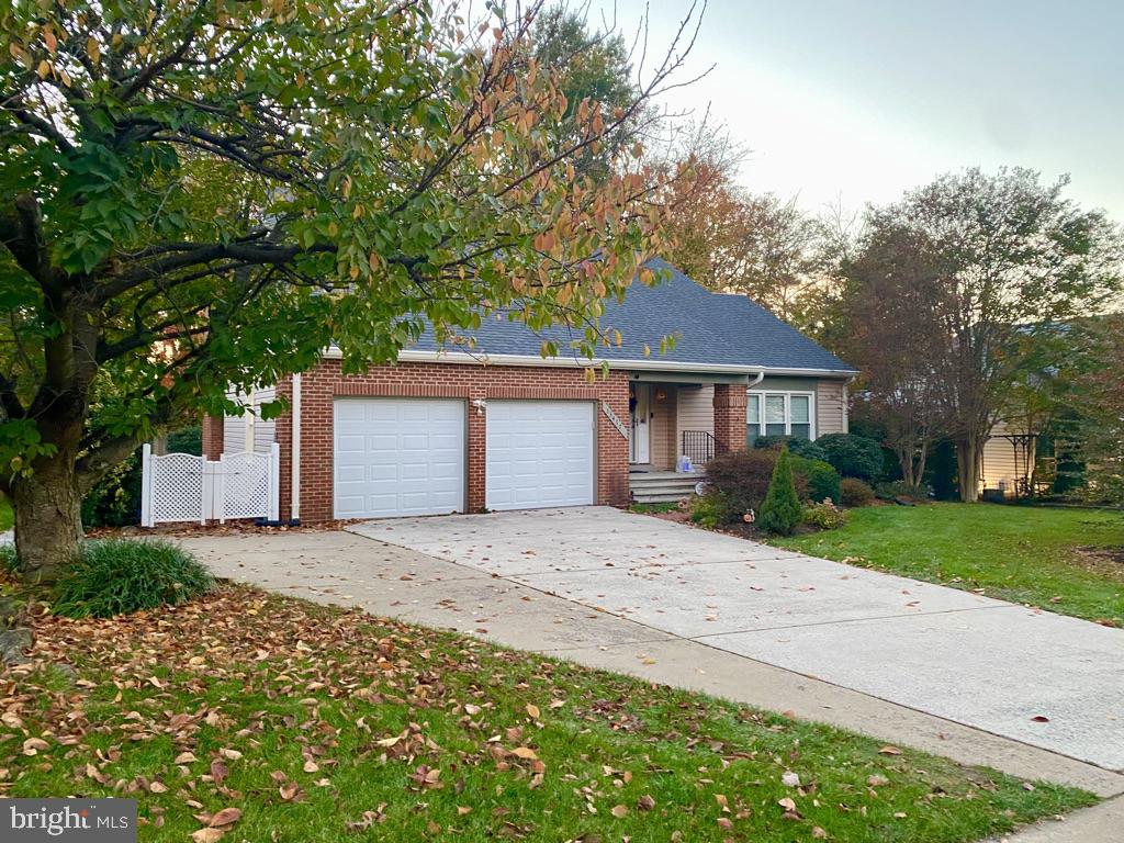 This exceptional home is situated on a beautiful lot that backs to woods in the sought-after Cavalier Woods neighborhood. It is artfully spacious  at almost 3,450 sq ft and is move-in ready. The home has been immaculately maintained and features magnificent landscaping and tasteful renovations. The inviting foyer welcomes guests as hardwood floors flow seamlessly throughout the formal living room with vaulted ceiling, dining room and family room featuring crown molding, chair railing, a wood burning fireplace, and renovated powder room. The updated kitchen boasts white cabinets, a gas cook-top, double ovens, quartz counter tops, newer appliances, a versatile island and a huge pantry that provides tons of extra storage. On the upper level you will find two guest rooms, a full-sized bath, and the primary suite with vaulted ceilings, a large en suite bath complete with a soaking tub and separate shower, 2 vanities, a large walk-in closet, and a sitting room/office/nursery with an additional closet. To make life convenient, there are laundry hookups on every level. The walk-up lower level features a mother-in-law/ au pair suite with separate kitchen, full bath, bedroom, living area, numerous closets and an additional storage room. Cavalier Woods is conveniently close to shopping, restaurants, grocery stores & gas stations, to include Trader Joe’s, Costco & Wegmans just down the street.
 Notables: Hardwoods & wooden stairs, newly tiled fireplace, renovated kitchen, newer roof with architectural shingles and 6" gutters, enclosed porch, whole house water filter, sump pump, mother-in-law suite, newer hot water heater, newer furnace, newer Pella double pane windows & more!