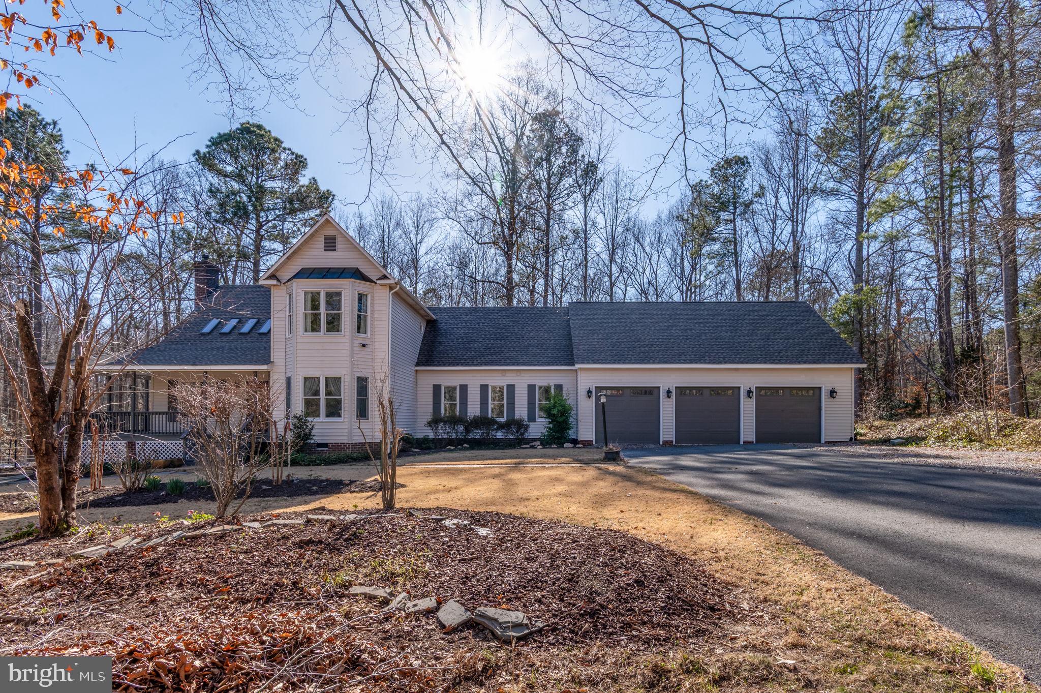 Absolutely stunning! This beautifully updated 4-bedroom home sits on 2.2 acres, just 18 minutes from Short Pump. Enjoy the serenity and charm of the wrap-around porch. The kitchen boasts a GE Cafe gas cooktop, electric oven, and a newer KitchenAid refrigerator, flowing into a dining area with a wood-beamed cathedral ceiling, one of two family rooms. Anderson and Pella windows flood the home with natural light. The first-floor primary bedroom is spacious at 22x13, complemented by a fully remodeled bath featuring Quartz counters, heated Venetian stone floors, an open shower, and a large Jacuzzi tub with an additional heater. Plus, a sizable walk-in closet and a Rinnai tankless water heater for endless hot water. Need space for a large vehicle? The oversized doors on the 3-car garage are perfect. A trail behind the property leads to the South Anna River, and there's even a chicken coop with resident hens for fresh eggs daily. This property is meticulously maintained and thoughtfully designed!