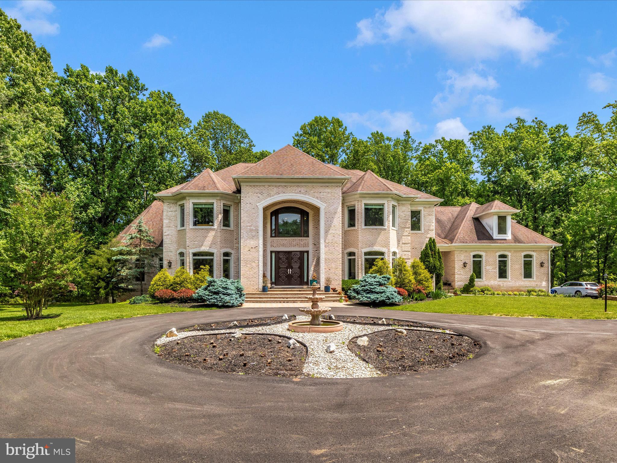 Please submit your best offer by Wednesday at noon. Openhouse is canceled for next Sunday.

Situated in the sought after River Hill school district, this estate residence covers a 5.5-acre lot and offers 12,457 square feet of luxurious living space with high end finishes and amenities. This home is a fusion of luxury and functionality, designed for both grandeur and practical living.  The home includes 7 bedrooms and 8 bathrooms, along with a completely finished basement, making it ideal for extended or multi-generational families. The home features hardwood floors on the main and upper levels, a spacious 3-car garage, and a large driveway that can accommodate about 5500 square feet, offering plenty of parking space.  The expansive outdoor area presents various possibilities for activities and leisure.

MAIN FLOOR - Step through the Barcelona-imported, intricately carved wooden doors into a realm of sophistication. The grand two-story foyer immediately captivates with its luxurious marble floors and elegant staircases ascending on both sides. The house reveals a stunning open design, guiding you to a formal living and dining area, each enhanced with tasteful lighting coves. Beside the living room lies a bright conservatory or study, and a functional double-sided Butler's pantry adjoins the dining room. The family room, a two-story wonder, features a striking dual-sided fireplace and leads to a sunlit sunroom and a vast 36-foot deck. At the heart of this home is the gourmet kitchen, complete with a large breakfast bar, pristine granite countertops, custom 42-inch cabinets, and top-tier stainless appliances, including a Sub-Zero refrigerator. For convenience, there are two kitchen areas: a primary one for entertaining and a secondary, fully-equipped chef's kitchen for daily use. Savor peaceful backyard views from the breakfast room or the connected sunroom, highlighted by tall windows with graceful arched transoms. The master suite is a retreat of comfort, offering a tray ceiling, personal wet bar, and a snug sitting area with deck access. The luxurious en-suite bath, featuring a sumptuous soaking tub and glass shower. The suite is completed with spacious walk-in closets, perfectly organized. 

UPPER LEVEL - Take the secluded rear staircase to the expansive upper-level sleeping area, where you'll find an additional family room and an open overlook. This level features four private en-suite bedrooms, each uniquely designed with bump-out details for added character and space. 
BASEMENT - The fully finished lower level is an entertainment haven, featuring a welcoming foyer that leads into an expansive family room. It's perfectly equipped for leisure with a billiards zone, gaming space, media area, and a full-service entertainment bar. This level also includes two additional bedrooms and a shared full bathroom, providing a comfortable space for overnight guests. A highlight of this area is the double walk-out leading to a covered patio, which opens up to a splendid rear outdoor living area and a separate, covered pavilion. For wellness and work, there’s a dedicated exercise room and a professional office. The utility room and additional storage closets ensure practicality and convenience. This home is further enhanced by a main level laundry room, sturdy custom steel framing, and rich Brazilian cherry floors. 
OUTDOOR - Relax on the welcoming front porch, the perfect spot to enjoy sunsets and take in the neighborhood views. Experience the epitome of leisure on the luxurious, concrete deck, offering a private retreat in the expansive backyard, ready to cater to any entertainment scenario you can imagine. Trees provide an extra layer of privacy.  This opulent home is the epitome of luxury and comfort, featuring all the amenities you could desire for an upscale living experience. Ideally situated near top-rated schools and major interstates 29, 32, and 95, it's perfectly poised to become your personal sanctuary.