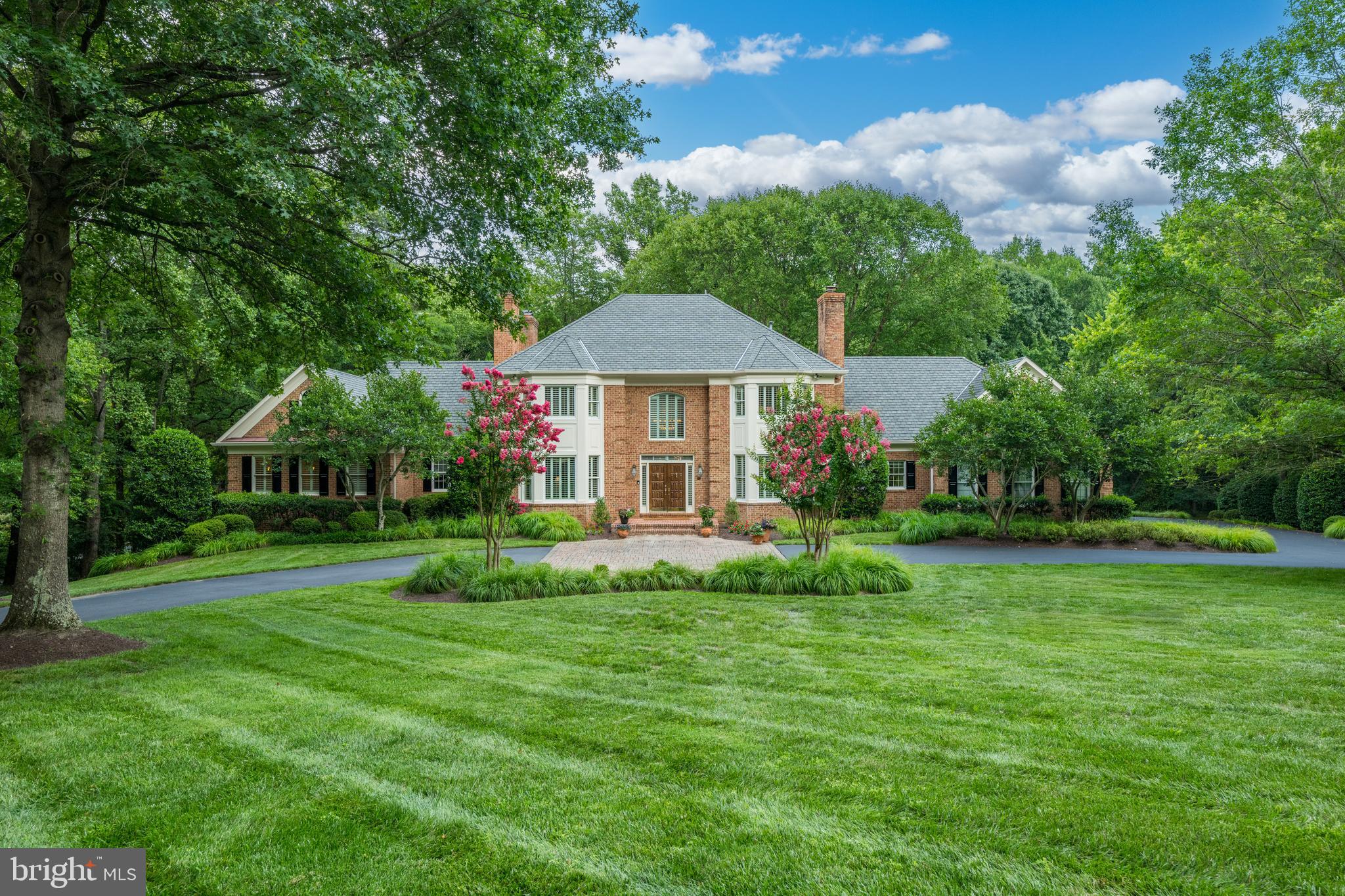EXCEPTIONAL NEW OFFERING IN VIENNA.  This custom-built residence, tucked away on a no-through street in Vienna's sought-after Hunters Crest neighborhood, is sited on a spectacular 2-acre lot with strong curb appeal just minutes from downtown Vienna and all major commuter routes. With over 8,800 square feet of finished living space, including 8 bedrooms, 8 full bathrooms, and 1 half bath, this stately home will delight the most discriminating buyer. Rich in detail, with elegant moldings and millwork throughout, the home features a main level primary suite, generous-sized principal rooms, and lovely outdoor spaces, including an expansive deck with picturesque views, screened porch, and patio.  This thoughtfully designed home features ensuite bedrooms, a bonus loft room, and a spectacular lower level with abundant windows with a recreation/media room, gaming and billiards area, kitchenette, exercise room, and additional bedrooms and baths.  This is truly the perfect place to call home!
