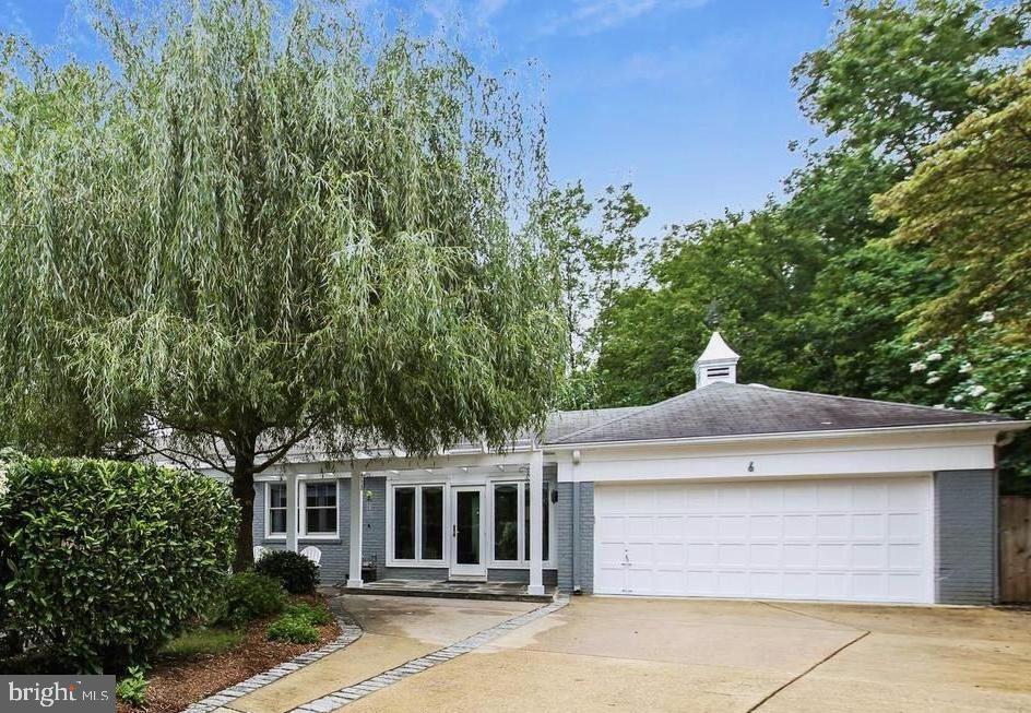 NEW ON MARKET! Tucked away at the end of a quiet cul-de-sac, this exceptional Spring Hill Court home perfectly blends sophistication, comfort, and convenience. Set on nearly half an acre in sought-after Chevy Chase, it combines the ease of city living with the serenity of a private retreat.
A welcoming foyer opens to a spacious living room with striking fireplace, flowing seamlessly into the dining room with French doors to the patio. Hardwood floors, recessed lighting, and refined finishes create a cohesive warmth and elegance throughout the main level.

The chef’s kitchen features restaurant-grade appliances, a cozy fireplace, and an open layout connecting the breakfast area and casual entertaining space, with direct access to the attached two-car garage.

The primary suite at the end of the hall includes a beautifully appointed Porcelanosa bath and thoughtfully designed closets, while two additional bedrooms share a stylish hall bath with a skylight and designer finishes.

The walk-out lower level adds incredible flexibility with two legal bedrooms, a full bath, a large family room featuring a dramatic fireplace and a large recreation space. Space and plumbing ready for a wet bar or kitchenette adds even more potential. Completing the level is a large laundry room with access to the deck.Outside, enjoy an expansive multi-tiered deck overlooking lush, landscaped grounds, your own serene escape in the heart of Chevy Chase.

Just moments from Metro, downtown Bethesda, NIH, Chevy Chase Lake, Rock Creek Park, and the North Chevy Chase Swim Club, this home seamlessly combines modern updates, timeless design, and a beloved neighborhood setting.