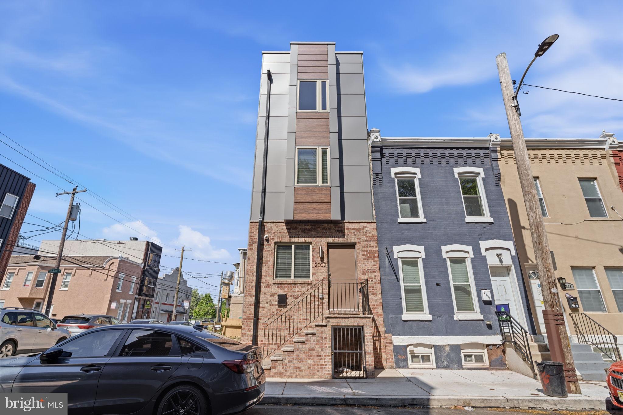 Welcome to 2002 Cleveland Street — a stunning new construction home in the heart of the Temple University area, offering the perfect blend of modern design, quality craftsmanship, and thoughtful functionality. This home also benefits from a 10-year tax abatement, providing significant long-term savings.
This beautifully designed 3-bedroom, 2.5-bath home features a spacious open-concept layout with high-end finishes throughout. From the moment you enter, you’ll appreciate the clean lines, abundant natural light, and efficient use of space that make every level feel both inviting and practical.
The main living area flows seamlessly into a sleek, modern kitchen equipped with premium cabinetry, quartz countertops, stainless steel appliances, and a stylish backsplash—perfect for both everyday living and entertaining. A rear door leads directly to the fenced backyard, making it ideal for grilling, outdoor dining, and relaxing in your own private space.
The second floor offers two well-sized bedrooms with generous closet space, connected by a beautifully finished full bathroom. The entire third level is dedicated to a spacious primary suite, providing a private retreat with a large bedroom and a well-appointed en-suite bathroom featuring contemporary fixtures and a clean, modern design.
The fully finished basement provides additional living space ideal for a family room, home office, or guest area. Enjoy outdoor living with both a fenced backyard and a private roof deck—perfect for entertaining or unwinding with city views.
Conveniently located within walking distance to Temple University’s main campus and Broad Street, with easy access to public transportation, this home offers an excellent opportunity for both homeowners and investors.
