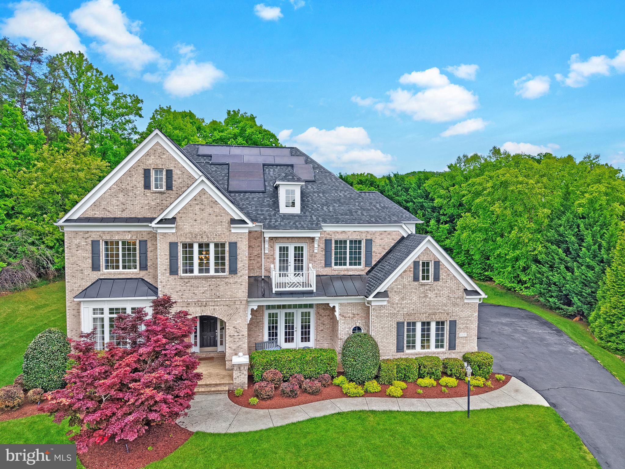 Located on a quiet cul-de-sac and set on nearly an acre in coveted Oak Hill Estates, this elegant brick-front home offers three beautifully finished levels with 5 bedrooms, 5 full baths, and 2 half baths, along with a desirable 3-car side-load garage.

A welcoming front porch leads into a bright, open floor plan featuring arched entryways, a dramatic two-story foyer, gleaming hardwood floors, and upgraded metal balusters. The main level includes spacious formal living and dining rooms, a private library, and a stunning family room with coffered ceilings and a stone fireplace that opens to the gourmet kitchen. The kitchen is designed for both everyday living and entertaining, complete with a large center island with secondary sink, stainless steel appliances, granite countertops, walk-in pantry, and an expansive breakfast area, plus an adjoining morning room filled with natural light. A functional mudroom offers a built-in desk, ample storage, and a large walk-in closet.

Upstairs, you’ll find stunning hardwoods in the upper hallway leading to four generously sized bedrooms. Each bedroom has an en-suite bath and a walk-in closet. There is also a versatile loft space and a large laundry room. The luxurious primary suite features a double-sided gas fireplace, a private sitting room, and 2 oversized walk-in closets. The spa-like primary bath includes a soaking tub and a seprate seamless glass shower and dual granite vanities.

The finished lower level provides exceptional additional living space with a large recreation room, fifth bedroom, full bath, and a flexible den ideal for a home office, gym, or guest suite. Additional highlights include abundant storage, a wet bar rough-in, and walk-up access to the private backyard.

Enjoy outdoor living on the spacious patio and screened porch, perfect for entertaining or relaxing. Ideally located close to shopping, dining, and everyday conveniences, this home offers a perfect blend of luxury, comfort, and functionality.