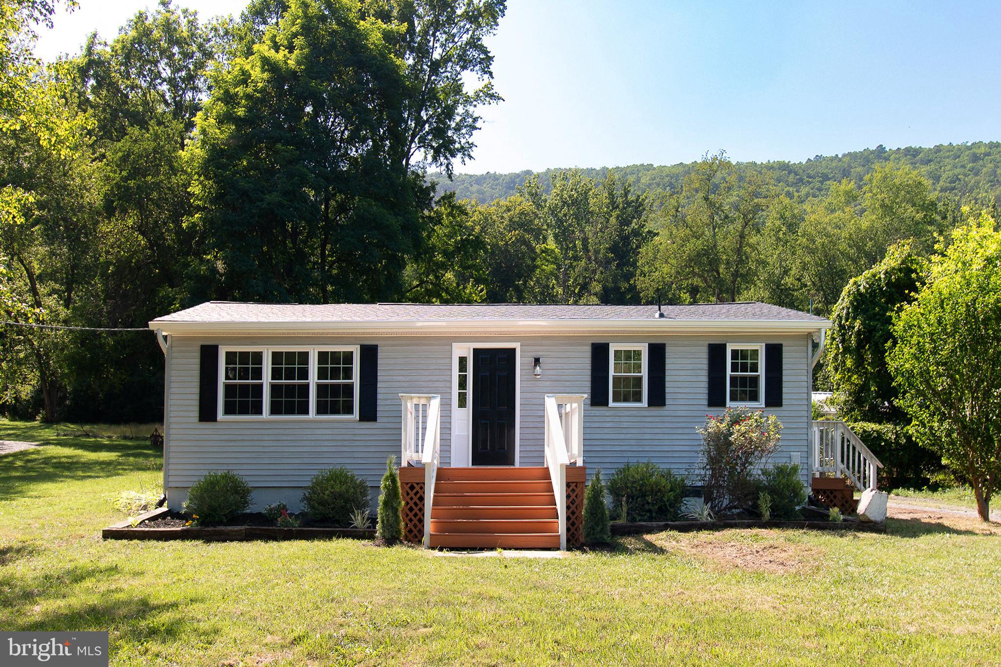 Run don't walk Completely REMODELED 3 bedrooms 2.5 bathrooms. Spacious ranch-style home offering over 2,000 square feet of one-level living on nearly a half-acre in Hampshire County. New Roof, New gutters with gutter guards, New HVAC central system, New Stainless steel Appliances, New Quartz Counter tops with backsplash, New kitchen cabinets, New garbage disposal, New LED lights, New water heater, New double-hung windows, Fresh Paint interior and exterior, 2.5 fully renovated bathrooms with shower set panel and shower glass doors with new water proof flooring, Jack and Jill bathroom between master bedroom and bedroom 2,  Pellet Burning Fireplace, Wood burning fireplace (option) in dining and storage areas, New Garage Doors with Remote Openers, New Garage Concrete Floor, New siding door and exterior door of workshop, New storage area door, A detached two-car garage with an upper-level workshop and balcony, plus additional kennel space, provides plenty of utility. No HOA,  Septic pump-out in June 2026, and much more. A MUST SEE !!!