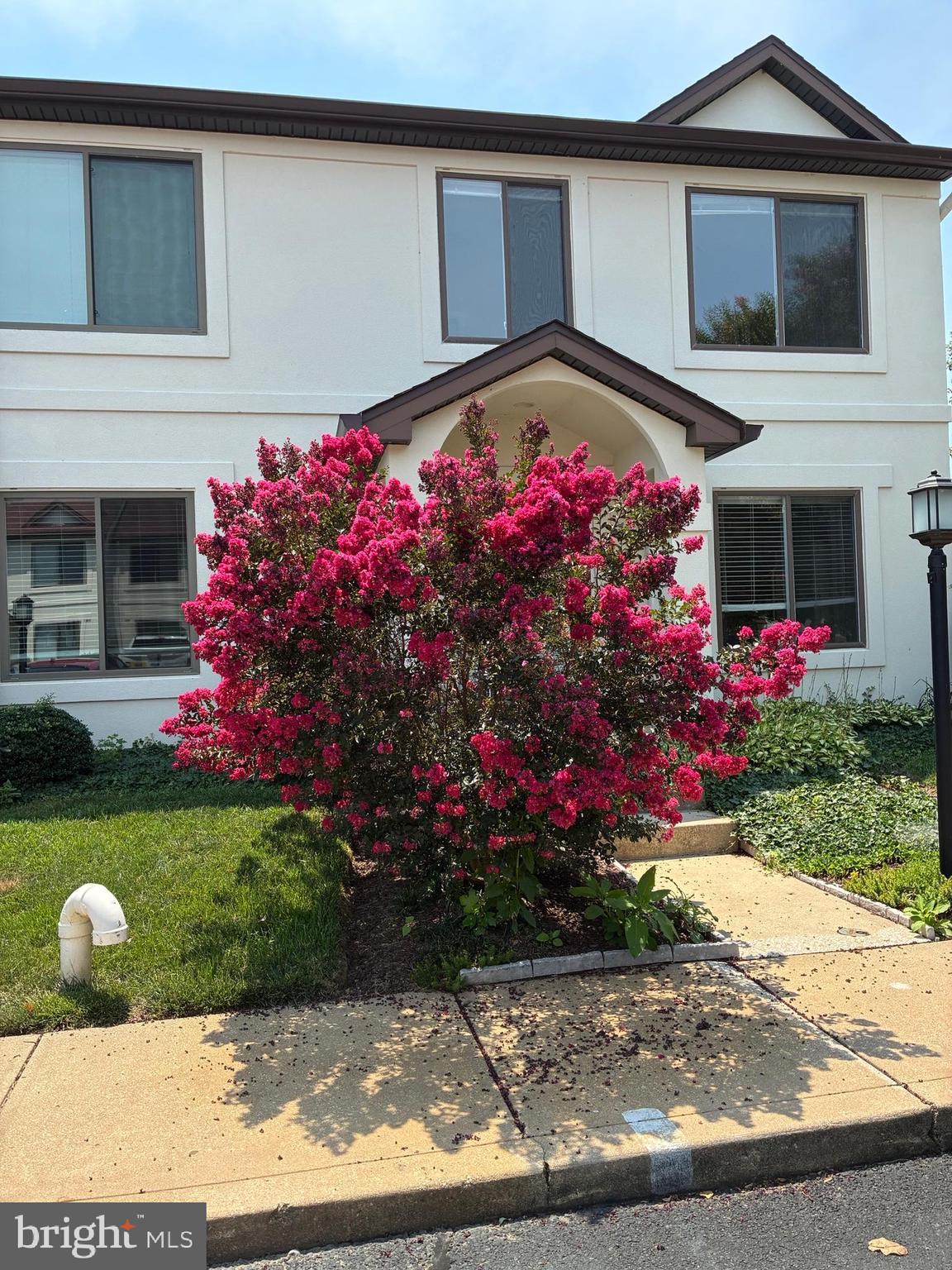 DON"T MISS OUT on this super deal!! Owners have lowered the price by $10,000 and are willing to look at offers! Nothing to do but move in! Be in this spring to enjoy all that summer offers on the shore!! This roomy 2 bedroom,  2.5 bathroom end unit has been completely painted in a beautiful neutral shade and has new carpet throughout the living areas and new vinyl flooring in the kitchen.  A propane fireplace highlights the great room turning chilly nights into cozy nights! On warm days, enjoy relaxing in the enclosed patio/porch or just being outside. Being an end-unit it offers lots of privacy. Any and all assessments have been paid by the owner, so you are ready to go and enjoy all the amenities that Queens Landing is known for...beautiful waterside pool, the club house with a party room, racquet ball court, exercise room, tennis courts, jogging trail, and more! Close to the cross-island trail, the Matapeake Dog Park, restaurants, schools, library...it is a wonderful place to live! Whether you are looking for a place to use as a vacation or weekend home, or as a year-round residence, this will suit both needs. It's situated in a great location...minutes to the Bay Bridge for any commuters to the western shore, and many airports,  and an easy drive to the MD and DE beaches! Note: 4 pictures have been Virtually Enhanced!