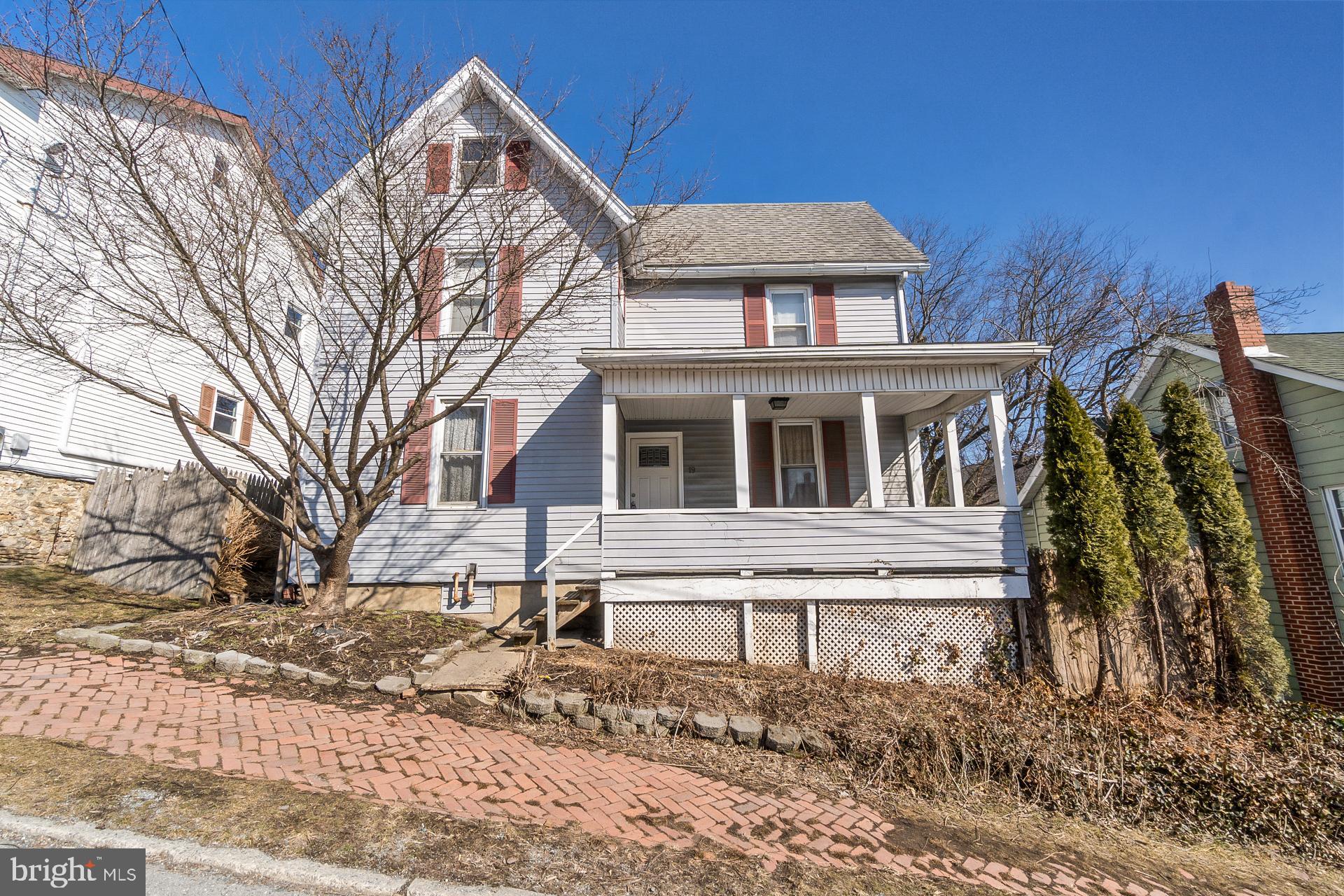 Welcome to a charming turn-of the century home in the heart of the Borough of Tamaqua.  This single-family house offers 2,125 square feet of living space and features four-bedrooms bursting with potential and awaiting the right buyers to restore it its former glory.  The large covered front porch welcomes you as you approach, offering a perfect spot for relaxation. Upon entering, you'll find a spacious living room with chair rail that leads to the dining room, and from there the layout seamlessly flows to the kitchen.  The kitchen features oak cabinetry, generous counter space, a dishwasher, and copper tone-stamped backsplash.  Both the kitchen and dining room provide access to the expansive back porch offering a peaceful view of the backyard.  Completing the first floor is a versatile room that currently contains an open half bath.  This space could be transformed into a fifth bedroom, with a suite, or repurposed for another use depending on your needs. As you ascend to the second floor, you'll find four bedrooms, one of which needs renovations and a full bath with claw tub.  A notable feature on this floor is the walk-in-closet in the hall.  Venturing to the third floor, you will find an attic with enormous potential to transform into additional living space.  Other highlights include a new oil burner and boiler unit installed 2025 and taxes under $2,000 annually.  Don't miss this chance to make this cherished Tamaqua gem your next dream home, schedule a showing today.