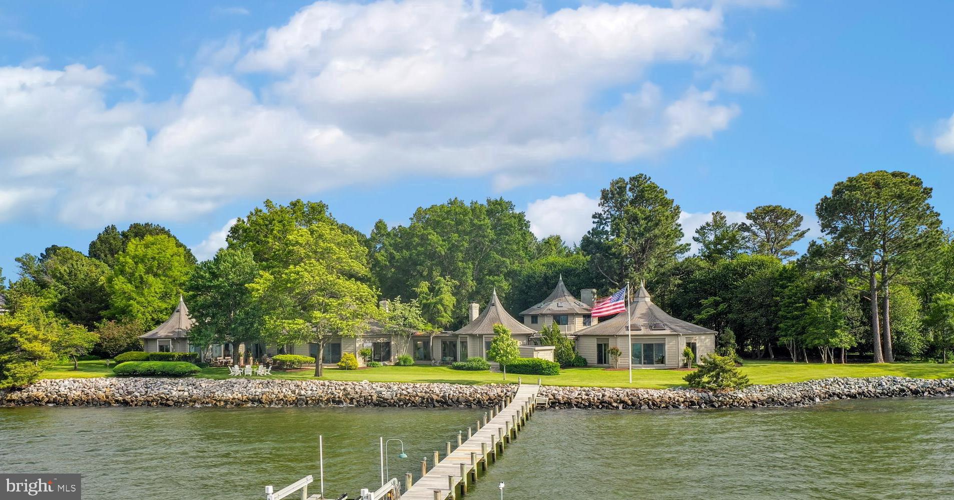 Welcome to Rivermark - a true waterfront retreat in St. Michaels on the Eastern Shore. This custom-built home is an artistic masterpiece with five octagonal interconnected wings, creating distinct yet flowing spaces and breathtaking panoramic views of Porters Creek, Miles River, Wye River and the Eastern Bay from every room.

With architecture inspired by the French West Indies, this home has been thoughtfully designed with both entertainment and relaxation in mind. Entering through the foyer, the heart of the home is the Great Room which contains soaring ceilings. This opens to a sun-drenched solarium with travertine flooring and floor-to-ceiling windows that wrap around the interconnected spaces of the sunroom, dining room, and kitchen.

Entertaining guests is effortless with the gourmet kitchen that is fully equipped with stainless steel appliances, an Aga stove, granite countertops, a large center island, and custom shelving/cabinetry. With both garden and water views the dual office/study spaces have custom floor-to-ceiling built-ins and wood paneling. The primary suite and a sanctuary unto itself, constructed with 18-foot ceilings and a spa-inspired en-suite bathroom fireplace and private outdoor patio. 

On the opposite wing of the home, you'll discover two additional bright bedrooms with custom lighting and a spacious shared bathroom. A unique feature of this property is the spa-inspired, glass enclosed swimming pool which overlooks the Miles River. The area is complete with an adjacent sunroom, green house, sauna, and full bath in this zen-like setting. A separate guest house provides privacy with its own entrance, offering two bedrooms, two bathrooms, a kitchen, and a comfortable living space. Outdoors, this property offers a rarely available opportunity of 750 feet of a rip-rapped waterfront, deep waters and a 150-foot private dock with boat lift - offering direct access to the Eastern Shore’s waterways and nearby waterfront dining.

The extensive professionally manicured landscaped grounds feature a tranquil koi pond with a fountain, lush gardens, abundant verdant trees, and brick patio with grill area. Rivermark was featured by the Talbot County Garden Club in the Maryland House & Garden Pilgrimage.

Don’t miss your chance to view this unique property in person to appreciate the incredible details. Experience the best of St. Michaels living at Rivermark—where luxury, comfort, and natural beauty converge in perfect harmony.
