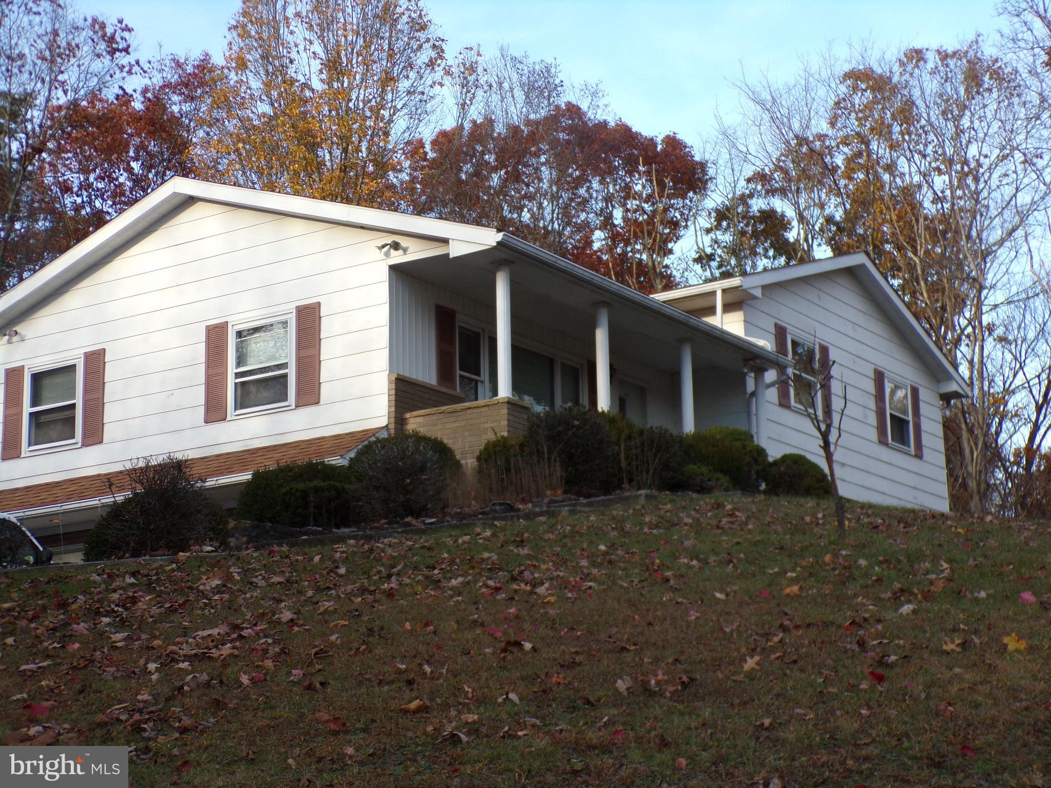PRICE REDUCED!!!  Welcome to this inviting 4 Bedrooms, 2 bath split level home, perfectly sitated in a peaceful, private setting.  This property offers a wonderful blend of comfort, functionality, and charm.  Step inside to find a bright and spacious layout, ideal for both everyday living and entertaining.  The main level features a welcoming living room that flows seamlessly into the dining room and kitchen, 4 comfortable bedrooms and a full bath.  The basement level contains family room , full bath, laundry , utility room and a one car built in garage.  For car enthusiasts or those in need of extra storage, there is also a one car detached garage with a full bath and a one car carport.  Enjoy relaxing on the front porch, perfect for morning coffee or greeting guests, or unwind on the rear enclosed porch, overlooking the tranquil backyard.  This well maintained property offers privacy and practicality, making it a wonderful place to call home!  The property has recently been surveyed and contains 9.2595 acres+-.