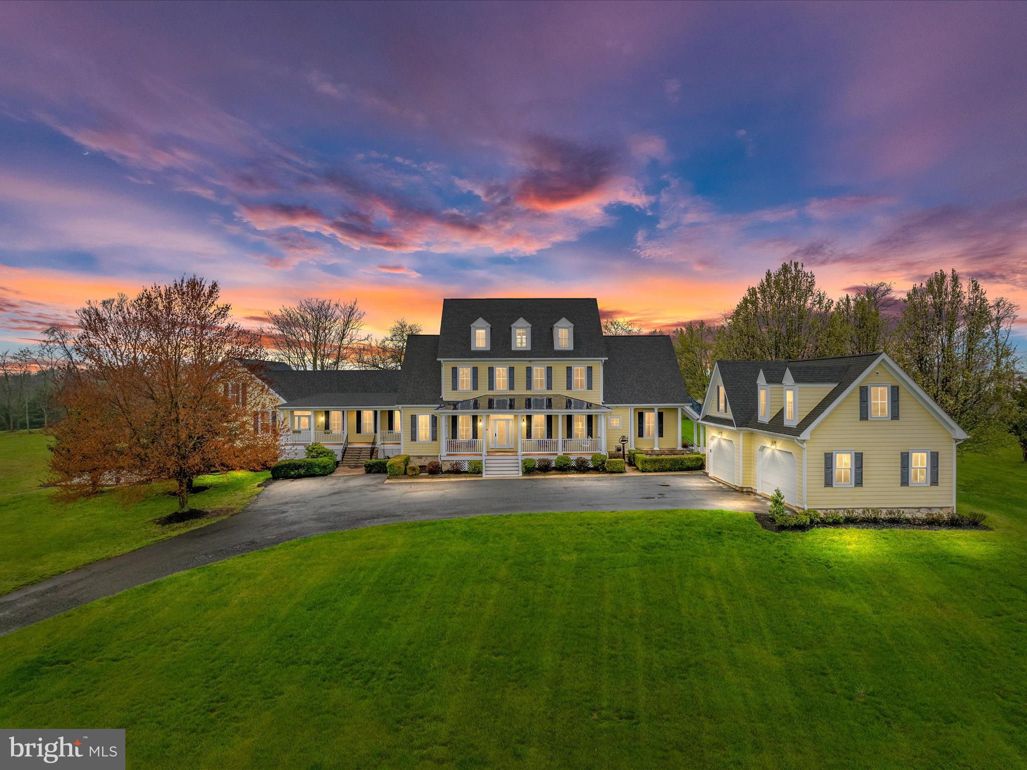 EXQUISITE CUSTOM FARMHOUSE ESTATE! Nestled on a breathtaking 11.1-acre parcel in the  elegant neighborhood of Catoctin Creeks, this charming home boasts unparalleled luxury and panoramic mountain vistas from every window! With  nearly 10,000 square feet of versatile living space, this masterfully crafted farmhouse exudes elegance and quiet comfort. Upon arrival, a sweeping long driveway leads to this well-designed home, where a stately Hardiplank exterior, dual front porches, and a meticulously designed 4-car side load attached garage with an accompanying apartment exudes timeless charm and elegance. The gorgeous interior is warm and inviting and features beautiful hardwood floors, tasteful paint decor, upgraded trim work, and designer lighting fixtures. The main level offers a private office with built-ins, a separate dining room ideal for entertaining, and a grand two-story family room with a gas fireplace. The heart of the home, the gourmet kitchen, is a chef's dream, featuring handsome white cabinetry, commercial-grade appliances, and an expansive island. The adjacent breakfast room boasts vaulted ceilings and breathtaking views. Wake up to picture perfect rolling hill views every morning from the main level owner's suite which features a newly renovated luxurious bath with separate shower and tub, a walk-in closet as well as access to the rear patio, the perfect spot to enjoy a cup of coffee. In 2010, a significant addition transformed this home, introducing a cozy hearth room and an expansive 26' x 40' living area. With its dramatic ceilings, abundant natural light, built-in bookcases, and loft space, this addition offers endless possibilities for versatile living arrangements. Upstairs, discover four generous secondary bedrooms and three full baths, as well as a fourth level loft with a large bedroom suite and a full bath. The walk-out lower level boasts a bright and spacious recreation room, ideal for entertaining, along with a custom theater room, convenient kitchenette, full bath and ample space for storage. Additionally, a private office/bonus room with a full bath and separate entry from the main floor provide flexibility and convenience. This home offers every modern convenience, including an energy-efficient 4-unit geothermal heating system and a whole-house generator for peace of mind. Outside, the meticulously landscaped exterior provides the ultimate retreat, featuring a stunning pool, expansive screened porch, beautifully designed paver patio with pergola, fire pit, and a vegetable/herb garden with raised beds creating a serene oasis for relaxation and entertainment. Whether you're working from home, pursuing hobbies, or caring for animals, this property caters to your diverse interests. The inclusion of a spacious red barn/work building with heat & A/C, complete with a separate driveway, enhances the property's versatility, offering ample space for both professional and/or leisure pursuits. Impeccably maintained and thoughtfully designed, this idyllic retreat in Purcellville offers privacy, elegance, and acres of breathtaking hillside views. Close to major routes for commuting and adventure, this is the epitome of refined country living. Property is in land use - Seller is not responsible for any roll back taxes. SELLER PREFERS COMMUNITY TITLE.