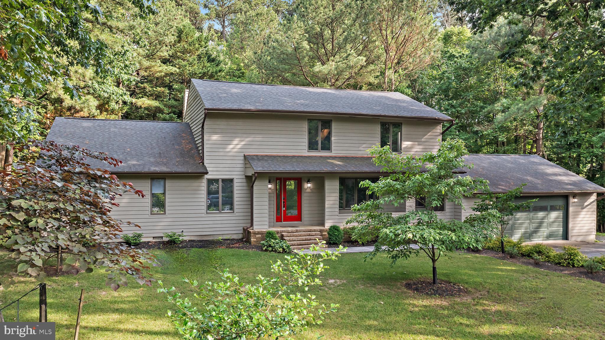 Enjoy a waterfront country club lifestyle with the privacy of wooded views at 4 Bunkers Court! This beautifully updated and private creek front home is tucked away on a wooded 1.53 acre cul-de-sac lot at the top of Little Greenwood Creek in the sought after waterfront golf course community of Prospect Bay. From soaring vaulted ceilings and over $100k of recent thoughtful upgrades throughout, this home combines comfort, style, and space indoors and out.

Step inside to a welcoming foyer and formal dining room with updated lighting. The showstopper of the home is the stunning family room featuring vaulted wood planked ceilings and a striking stone fireplace, an architectural focal point that adds warmth and character.

The updated kitchen is a chef's delight with new stainless steel Frigidaire Gallery appliances, granite countertops, freshly installed tile backsplash, new flooring, and a sleek hood vent. A cozy breakfast nook with custom built-ins offers extra storage and bar countertop seating. 

Just off the kitchen, you’ll find a new mudroom and laundry area with two additional storage closets and a newly added powder room, all connecting to the oversized two-car garage for everyday convenience.

The main level offers three bedrooms and two full bathrooms, including a serene primary suite with private patio access, two closets, and a fully updated en suite featuring a walk-in glass enclosed shower with overhead and wall mounted shower heads, and a double vanity with modern finishes.

Upstairs, a spiral staircase leads to a spacious and versatile loft ideal as a fourth bedroom, office, or entertaining space. This grand loft includes a game and TV area, pool table, full bathroom with designer tile and a glass shower door, and a custom-built bar area with a beverage fridge, microwave, sink, cabinetry, and backsplash perfect for hosting guests in style.

Outside, step onto your private bluestone patio and hot tub, surrounded by the natural beauty of your wooded lot. The sellers have explored the potential of building a boardwalk to the creek with a floating dock buyers to verify offering exciting possibilities for enjoying the waterfront setting.

Living in Prospect Bay means more than just a beautiful home, it’s a lifestyle. Enjoy first class amenities including a championship 18 hole golf course, tennis and pickleball courts, outdoor pool, clubhouse with dining, social events, boat basin, and more.

Whether you're hosting in the open concept living spaces, relaxing in your upstairs retreat, or soaking in the serenity of your private wooded backyard, 4 Bunkers Court is the perfect place to call home!