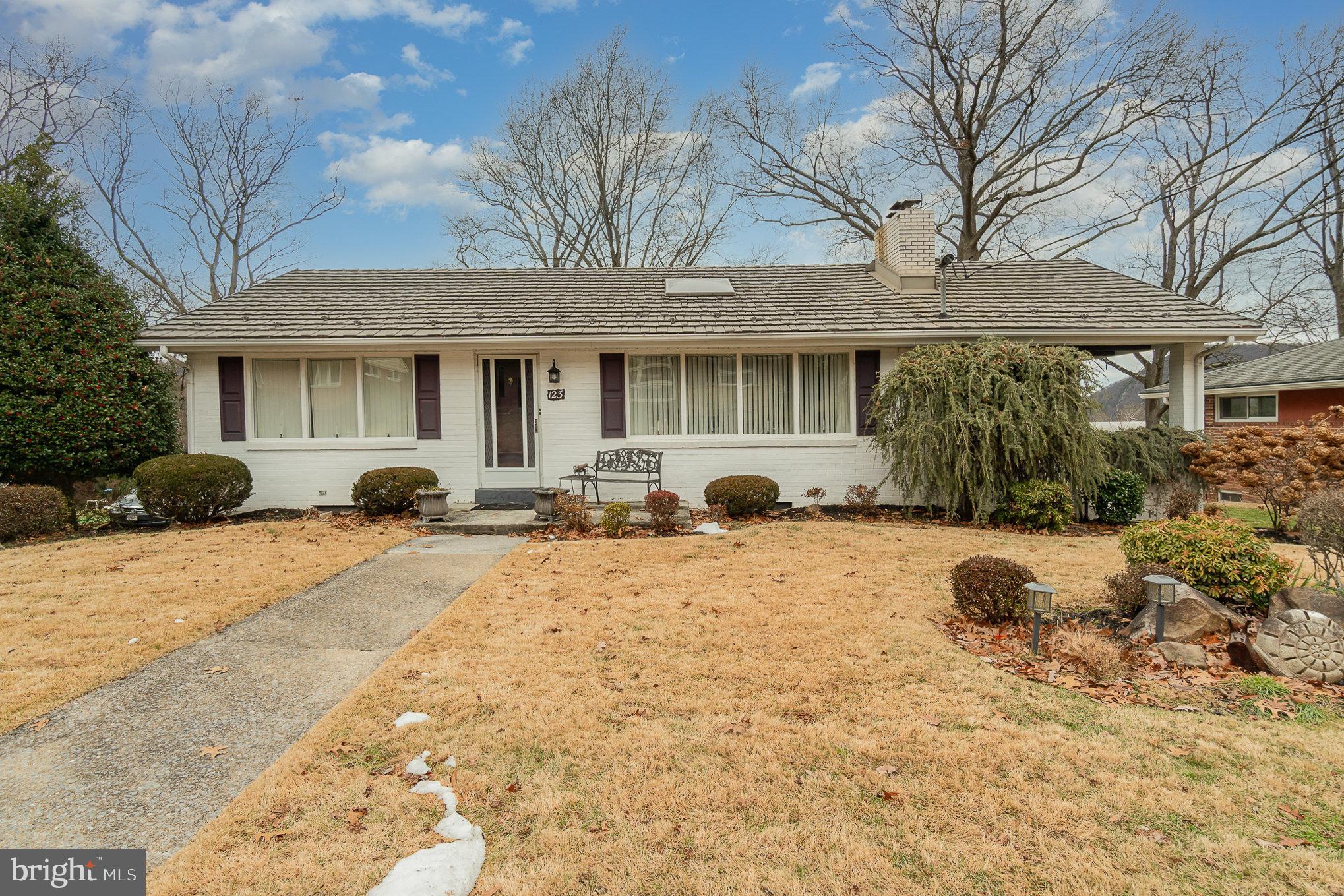 Your first impression will be " WOW" when you see this bright & cheery 4 bedroom, 2 bath  solidly built brick ranch with its very impressive metal roof that will last a lifetime.  From the moment you step inside this lovely and well cared for home, you'll be impressed with the soaring living room ceiling & gorgeous "wall of stone" fireplace. The warm & inviting kitchen offers, beautiful & lovingly built kitchen cabinetry with breakfast bar and plenty of counter space for serious cooking! The dining room with the huge sliding glass door, brings nature to you with its pretty views. Three bedrooms and a bath are on the main level along with a huge deck for entertaining  and cozy  covered patio right off the kitchen, the perfect spot for toasting Springs arrival with morning coffee!  Down stairs will usher you to a family room with is inviting fireplace, it the perfect  game room for entertaining  or watching the game. The semi circle retro bar offers a  wonderful time had with friends and family, raising a glass to your good fortune in owning this sweet find!  There is a 4th guest bedroom ,  Laundry room and Bathroom as well as Utility area for all your tools. Lets not forget the walk up attic ,plus a  one car garage, and outdoor storage area, a wonderful place for all your outdoor toys.
 The  outdoor covered patio off of the family room is the perfect place to steal away for a summer nap with a good book or take in the landscaping the backyard offers! It will be an absolute joy to see this beautiful property bloom come spring! Truly a warm, friendly and lovely home that you will not want to miss, so SPRING in to ACTION!  CALL NOW