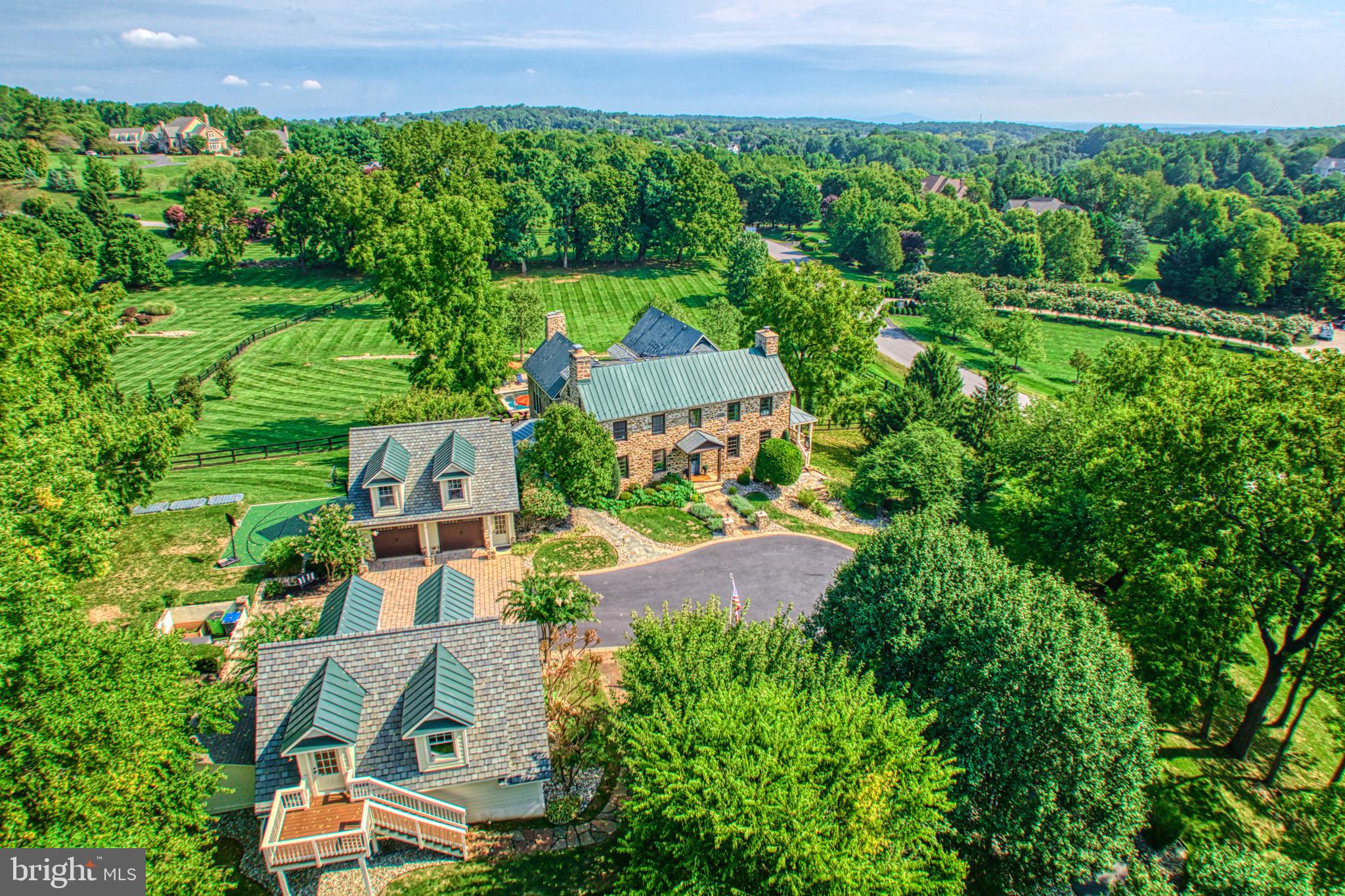 Welcome to an extraordinary fully renovated historic home in the heart of prestigious Beacon Hill, where timeless elegance meets modern luxury. Nestled on 6.46 picturesque acres, this exquisite property offers serene living with breathtaking views from covered porches and a stocked pond that invites peaceful reflection. This residence masterfully blends old-world charm with contemporary sophistication, showcasing meticulously preserved fieldstone walls and exposed beams. The gourmet kitchen, a chef's dream, flows seamlessly into a family room featuring a vaulted ceiling and a cozy wood-burning fireplace, creating the perfect setting for intimate gatherings or grand entertaining. The finished basement provides additional living space, ideal for a home theater, gym, or guest quarters. Outside, indulge in your private oasis with a sparkling pool, soothing spa, and a beautiful patio space, perfect for alfresco dining and relaxing under the stars. Experience the epitome of luxury living in this stunning Beacon Hill estate, where every detail has been thoughtfully crafted to honor the home's rich history while offering the finest in modern amenities.