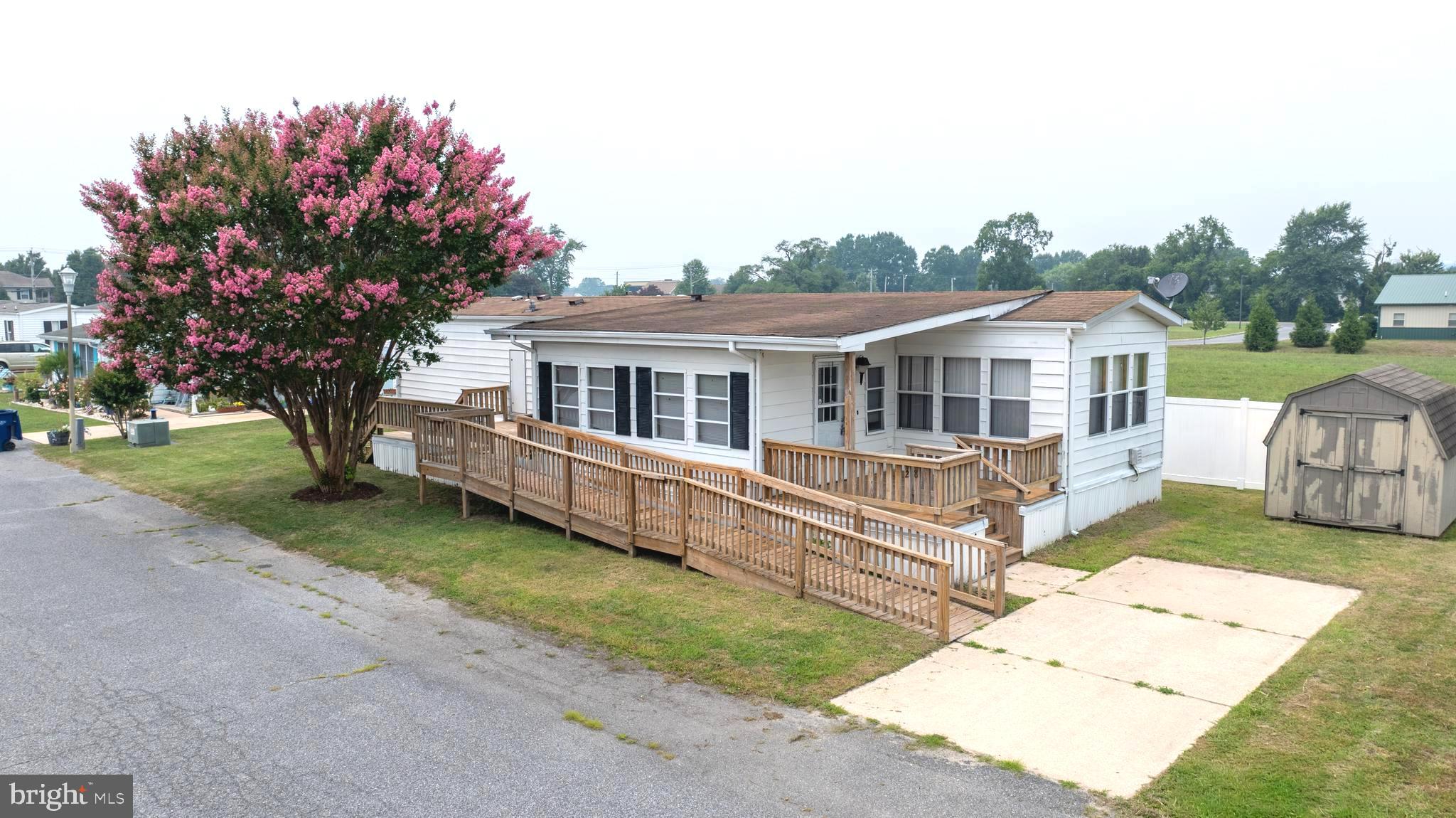 Welcome to Hub Court West, a 55+ community! This 2-bedroom, 2-bath home offers approximately 1,000 square feet of living space and features a spacious living room, enclosed front porch, front deck, and handicap-accessible ramp. Conveniently located close to Delaware beaches, shopping, dining, and local attractions, presenting a great opportunity for buyers looking to personalize a home in an established community. Whether you’re looking to downsize or searching for a second home, this property offers great potential. 
This property is part of an ESTATE sale and is being sold As-IS.    Monthly lot rent is $630. Park approval is required.