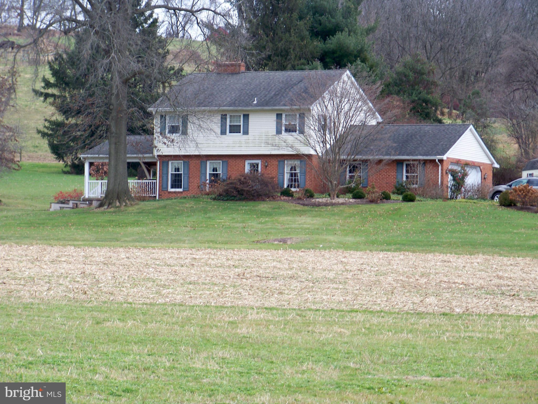 NOTICE - PRE-AUCTION OFFER ACCEPTED BY SELLERS. ALL AND BEST OFFERS DUE BY 12 NOON ON THURSDAY, MARCH 21, 2024. 
This Property Is Nothing But Amazing With 15.8 Acres Of Prime Land Offering Approx. 8+ Acres Of Tillable Land, Small Barn, Storage Shed, Two Streams And Possible Pond.  Farmland Preserved! The Well-Maintained Colonial Home Sits Well Back From The Road Offering Privacy. Step Inside The Front Door  With Living Room w/ Wood-Burning Fireplace To Your Left And Dining Room To The Right. The Updated Kitchen Features Granite Countertops, Walk-In Pantry, Propane Stove & Breakfast Bar. Large Family Room w/ Vaulted Ceiling & Brick Hearth For Stove. Attached Two-Car Garage w/ Laundry. Upper Level Hosts Four Bedrooms & Two Full Baths. Partial Finished Basement Features Sitting Area w/ Flu & Brick Hearth  For Stove & Large Game Room. Entertain From Your 16' x 32' Outdoor Covered Porch, Above Ground Pool & Half Basketball Court.  This Is A Must-See Property!