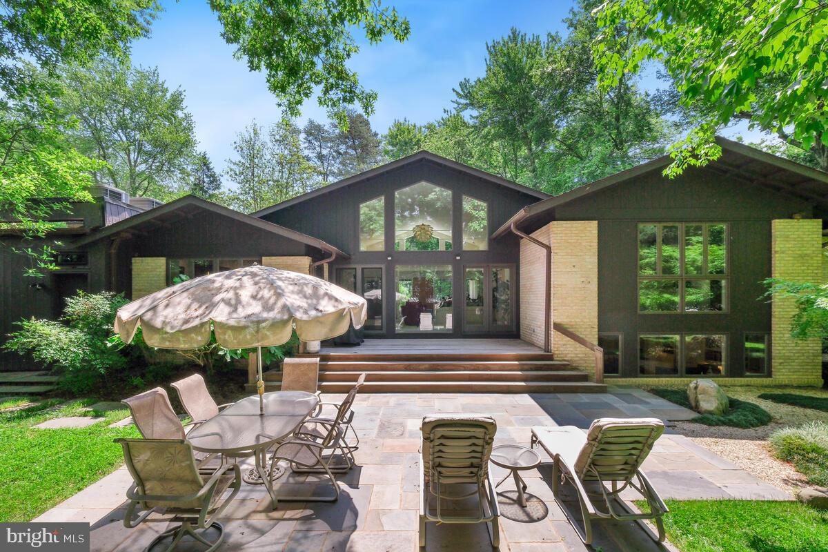 Welcome to this exquisite 4-bedroom, 3.5-bathroom residence offering unparalleled luxury and comfort in the sought-after Luxmanor community. Set on over half an acre of professionally landscaped property, this home provides a private and secluded oasis complete with a professionally designed vegetable garden and outdoor illumination. Upon entering the walk-in level, you are greeted by a welcoming foyer that flows seamlessly into the expansive living room, boasting dramatic cathedral ceilings and oversized windows that flood the home with natural light. Oak floors and recessed lighting throughout the entire home enhance the elegance of this space. The formal dining room offers serene backyard views, while the recently remodeled kitchen is a chef's dream, featuring a wall oven, convection/microwave oven, warming drawer, Sub-Zero refrigerator, 5-burner gas stove, all stainless steel appliances, custom backsplash and cabinetry, a kitchen sink outfitted with a reverse osmosis water filtration system, and a breakfast area with skylights. The family room, just steps away, includes built-in shelving, a gas fireplace, abundant windows, and cathedral ceilings, providing the perfect space for gathering. The upper level includes a full bath, a bedroom with gorgeous backyard views, and a second bedroom with built-ins, perfect for use as a home office. The generous primary bedroom features two walk-in closets and a spa-like primary bath with a double vanity, heated floors, large shower, Jacuzzi tub, and skylight. The lower level offers a large recreation space with built-in shelving, a full bedroom, a full bathroom, a large custom home office - fully equipped with high-quality built-in desks, and a laundry room with access to the backyard. Enjoy the community-centered neighborhood with an abundance of amenities and activities year-round. There's something for everyone with a community pool, active swim team, tennis courts, a local park, and hiking trails. Close to unlimited shopping, dining, and entertainment venues, including Pike and Rose and NoBe Market, this one-of-a-kind home offers the best of North Bethesda!