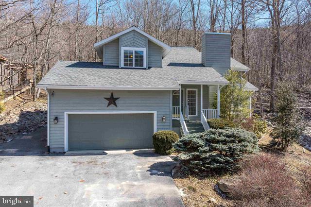 This Massanutten Resort home, ideally located in the Kettle of Massanutten and bordering the George Washington National Forest willmake the perfect primary residence, Short term rental, or second home. Enjoy incredible views of the ski slopes from your front porch! This lovely home features a spacious and inviting floor plan, including a cozy wood-burning fireplace in the living area. The master suite offers a private retreat with a full bath and a generous walk-in closet. The kitchen has an island, breakfast nook, and formal dining room perfect for entertaining. Step outside through the patio doors to relax and unwind on the deck or enjoy a soothing soak in the hot tub. The upper level includes three additional bedrooms and a full bath, providing ample space for family and guests. Roof replaced in 2021. This home is perfectly situated close to the stunning Shenandoah National Park, Skyline Drive, Luray Caverns, and all the wonderful attractions of the Shenandoah Valley, including breweries, shopping, dining, and historical landmarks. A truly exceptional place to call home!